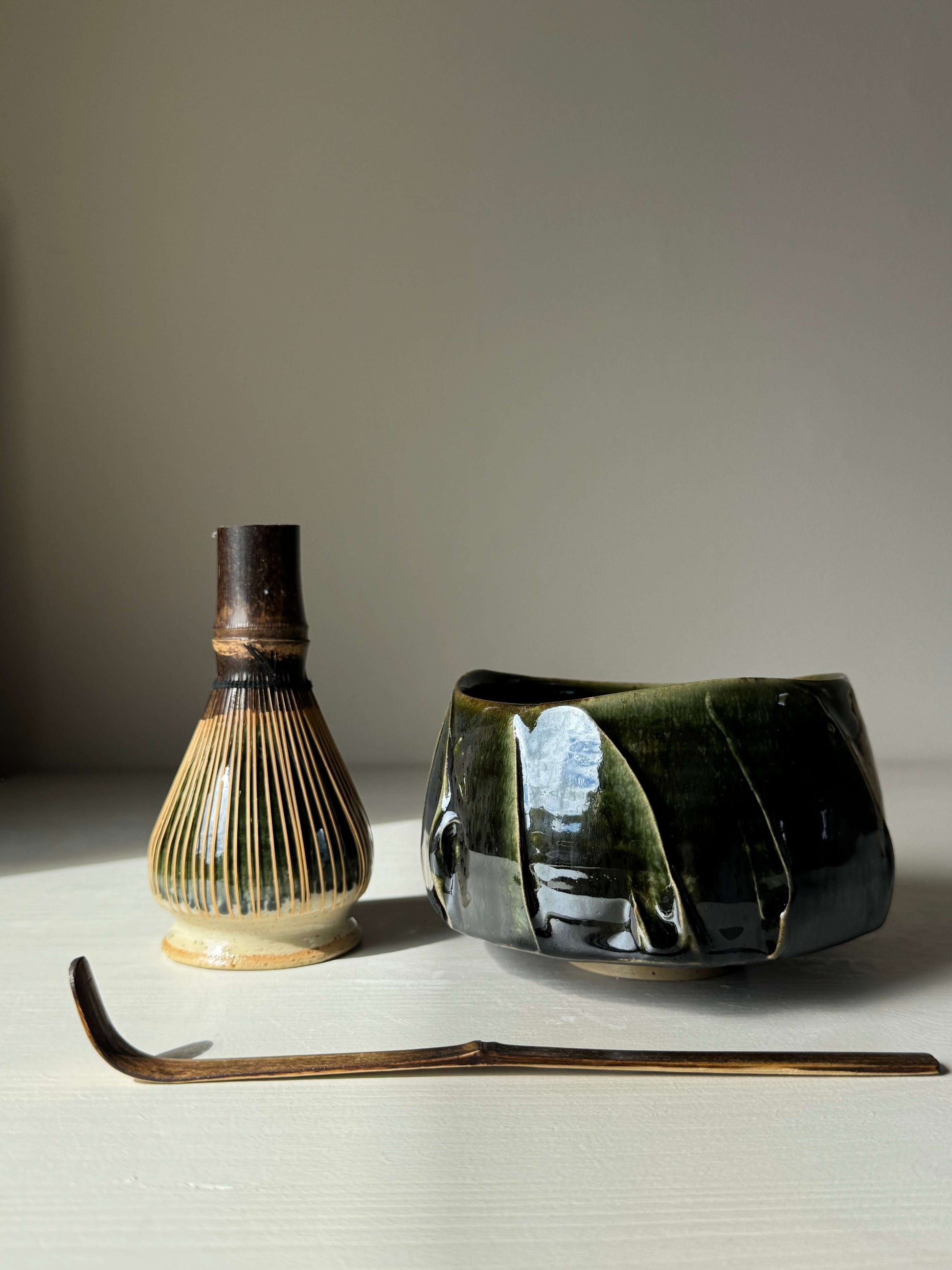 Handmade ceramic Textured Matcha Bowl - Hinoki Series #12 with bamboo whisk and scoop on display.