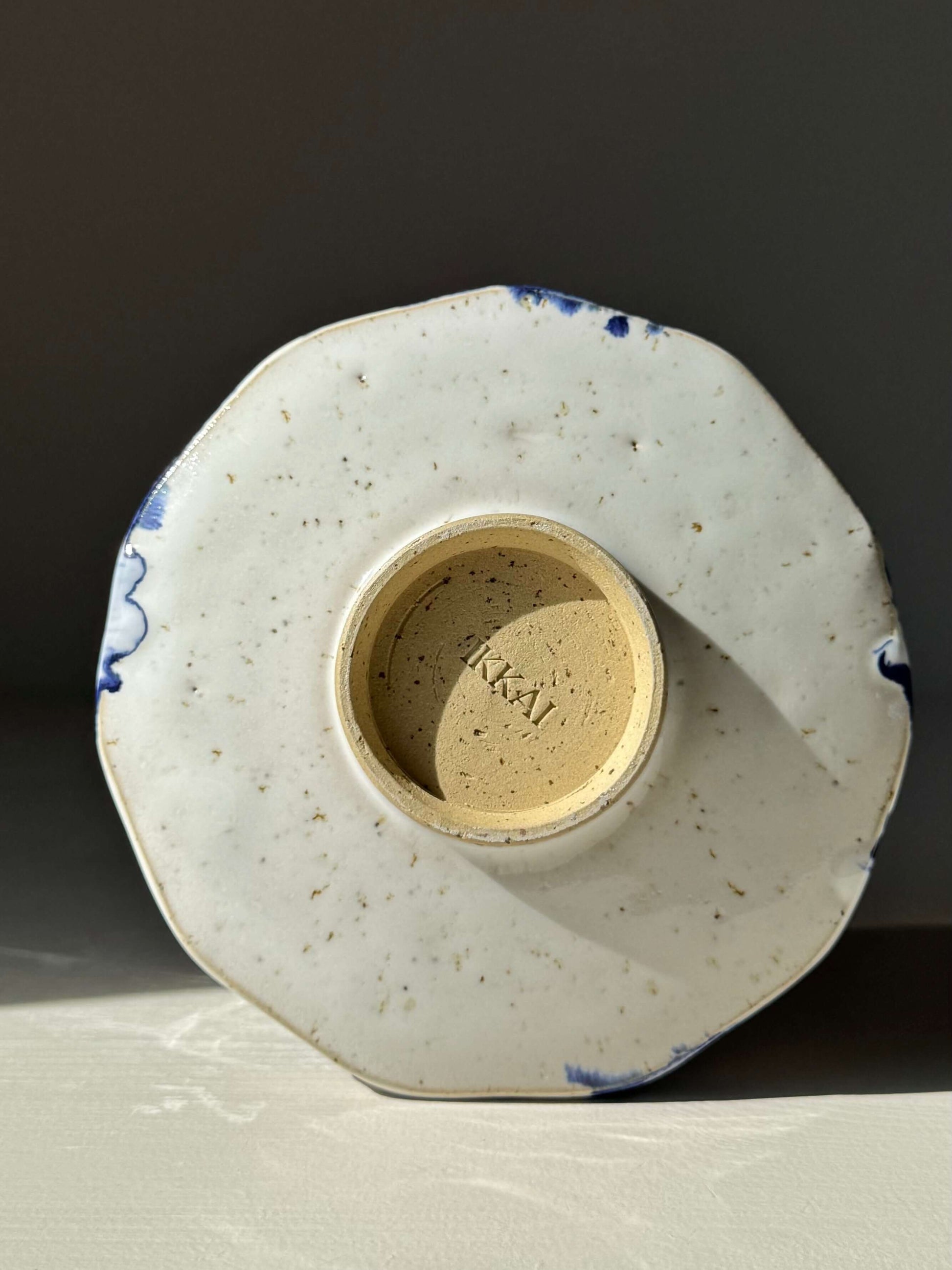 Bottom view of Faceted Matcha Bowl with Spout – Cobalt Blue & Glossy White Glaze #06, highlighting the handmade ceramic texture.