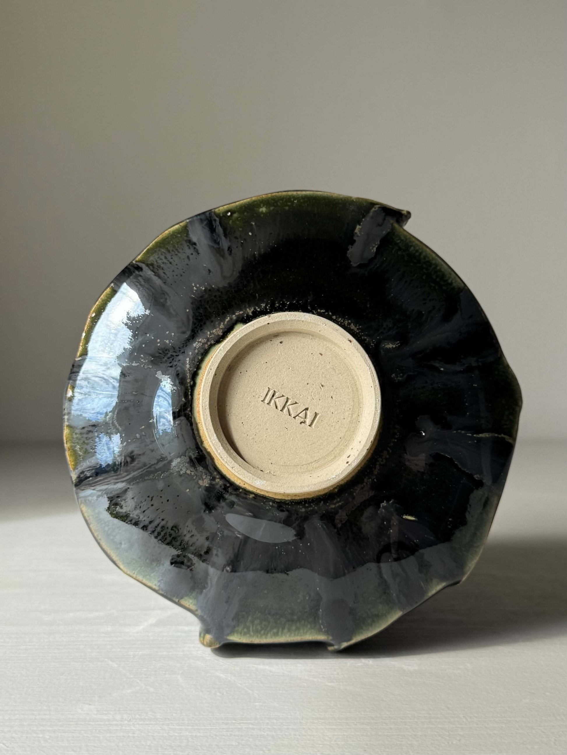 Bottom view of handmade ceramic Textured Matcha Bowl - Hinoki Series #09 with black glaze and artist's mark.