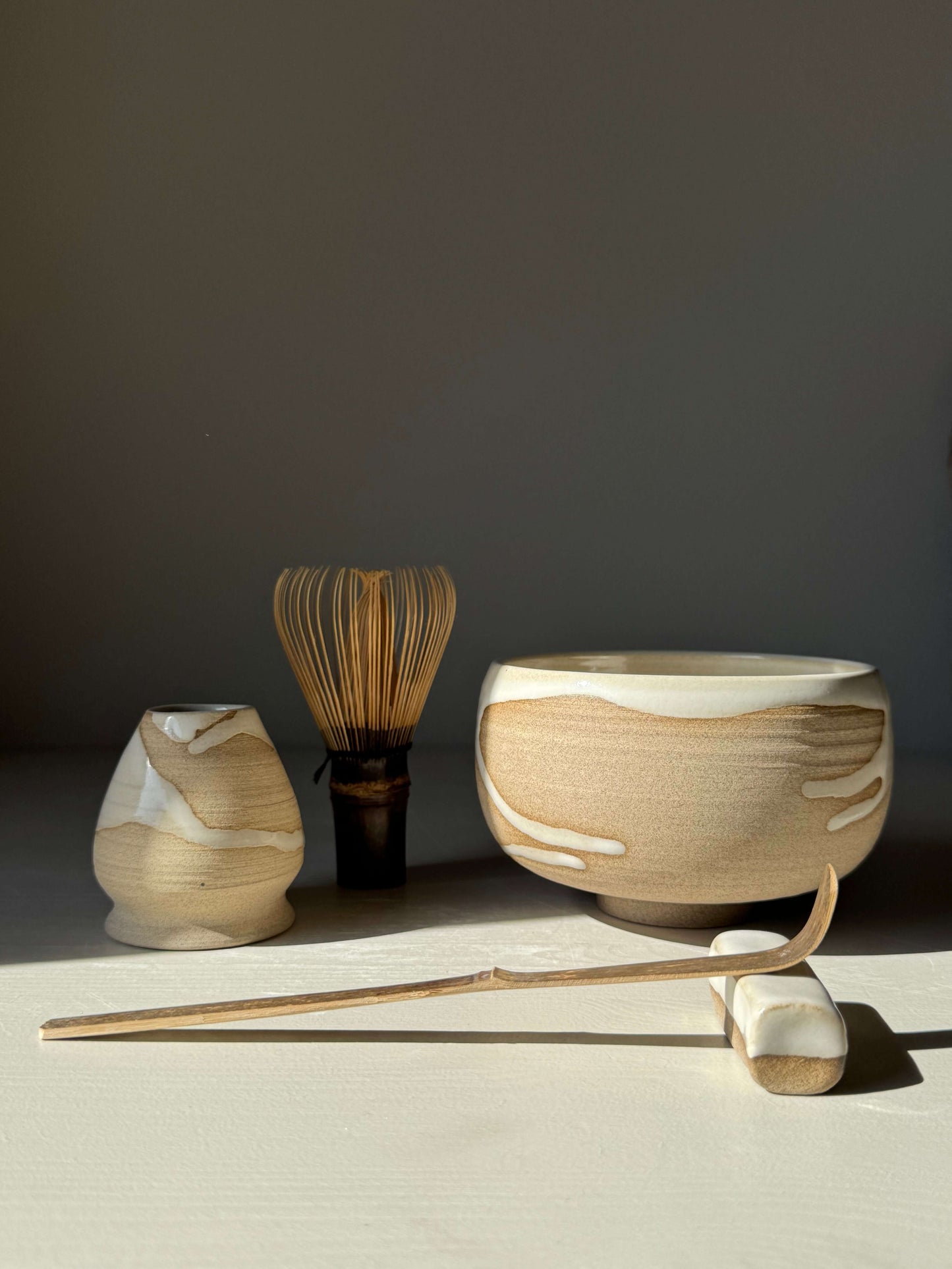 "Matcha Bowl – Yuki Series #02" handmade ceramic set with whisk, scoop, and bowl in natural light