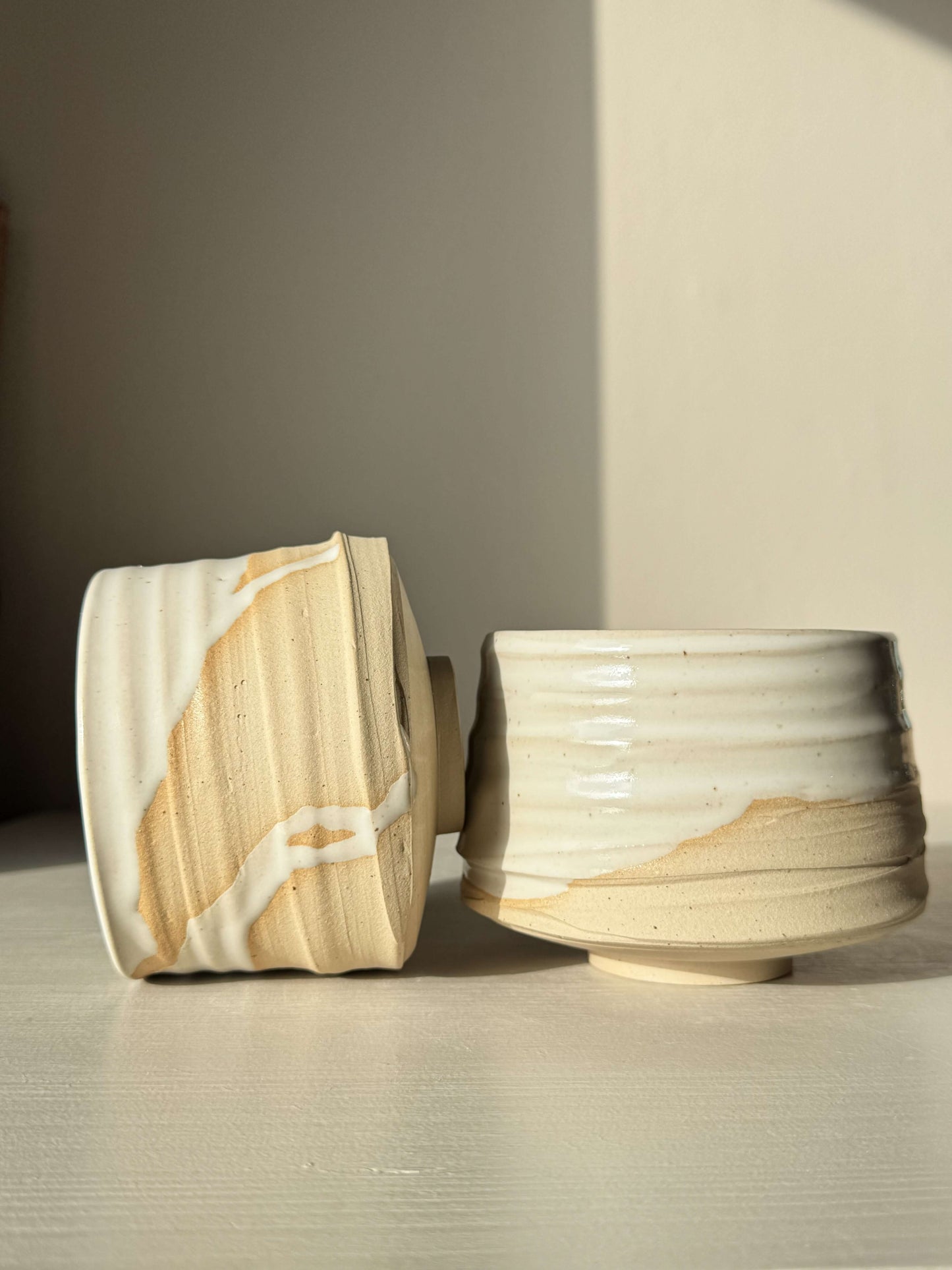 Handmade ceramic Matcha Bowl – Half Glossy White Glaze #02 showing speckled stoneware with white glaze drips and raw clay accents.