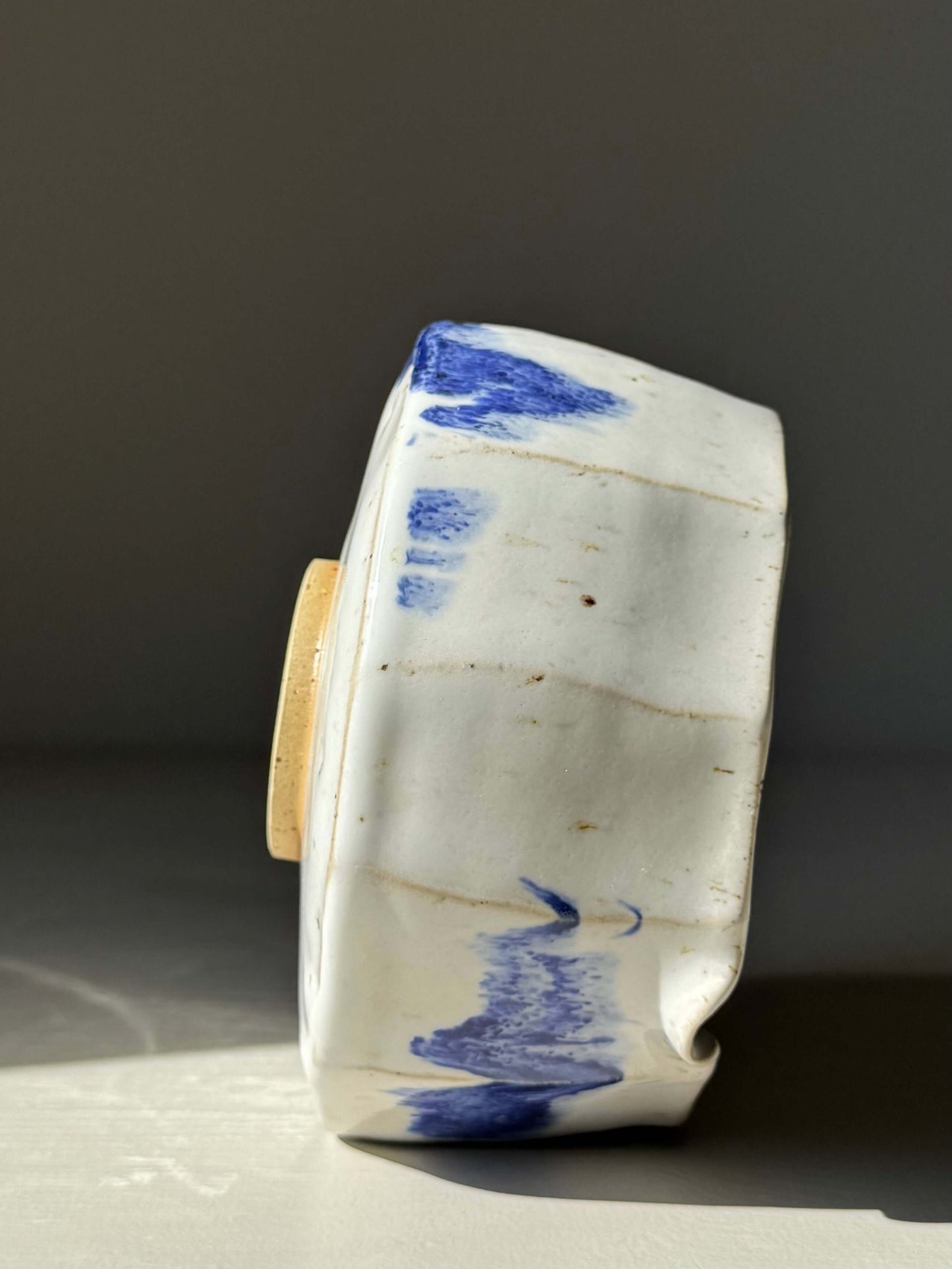 Side view of Faceted Matcha Bowl with Spout – Cobalt Blue & Glossy White Glaze #05, showcasing handmade ceramic with blue accents.