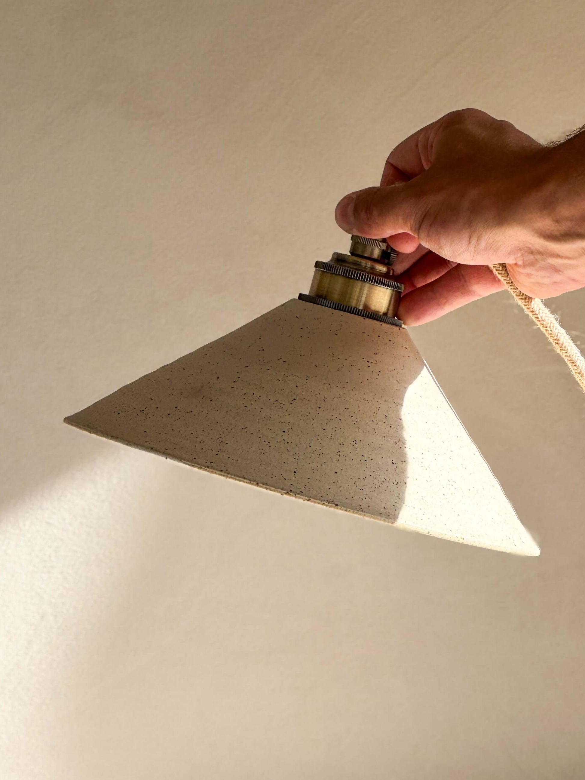 Hand holding Ceramic Lamp Shade – Half Glossy White Glaze, handmade ceramic with raw unglazed exterior and glossy interior.