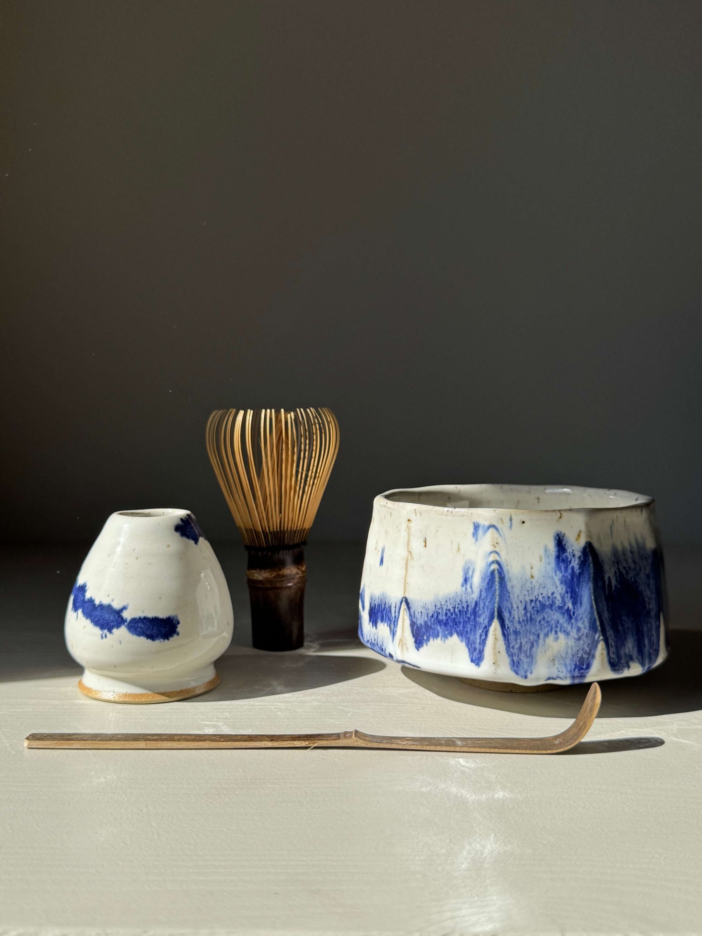 Handmade ceramic Faceted Matcha Bowl – Cobalt Blue & Glossy White Glaze #01 with tea utensils.