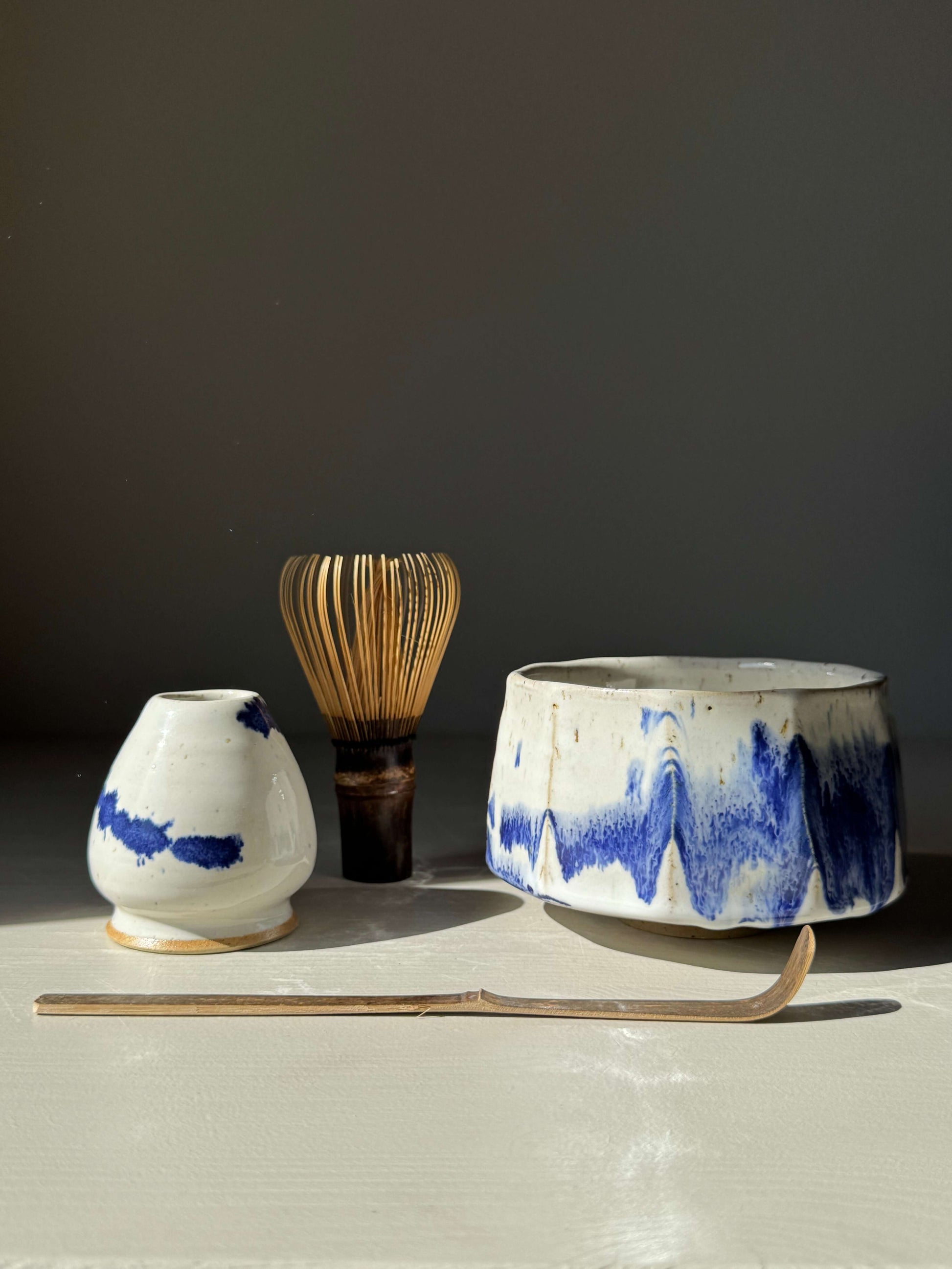 Handmade ceramic Faceted Matcha Bowl – Cobalt Blue & Glossy White Glaze #01 with tea utensils.