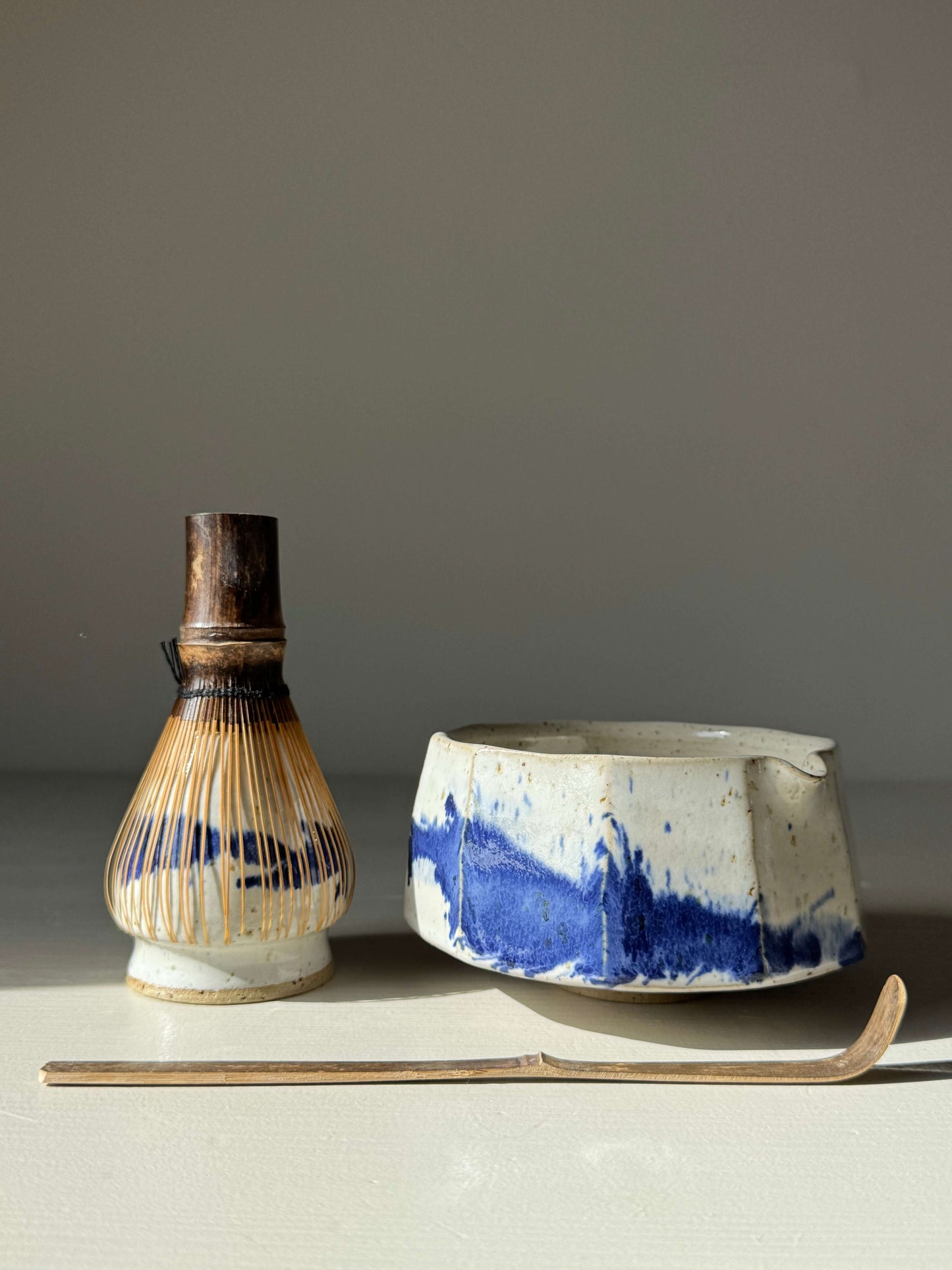 Faceted Matcha Bowl with Spout – Cobalt Blue & Glossy White Glaze #09, handmade ceramic bowl with whisk and spoon, modern aesthetic.