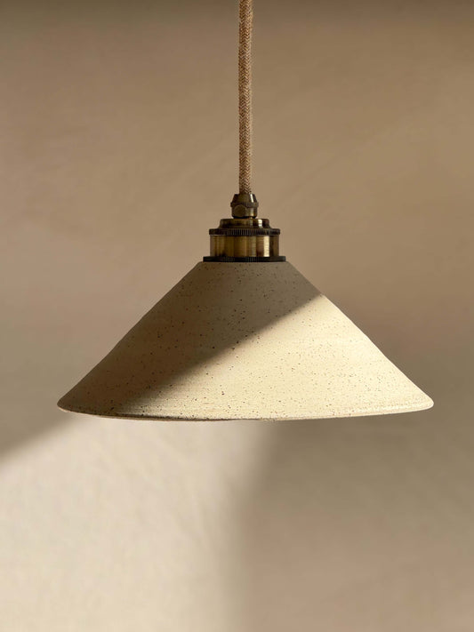Handmade Ceramic Lamp Shade – Half Clear Glaze #01 with unglazed exterior and clear glazed interior, hanging in warm light.
