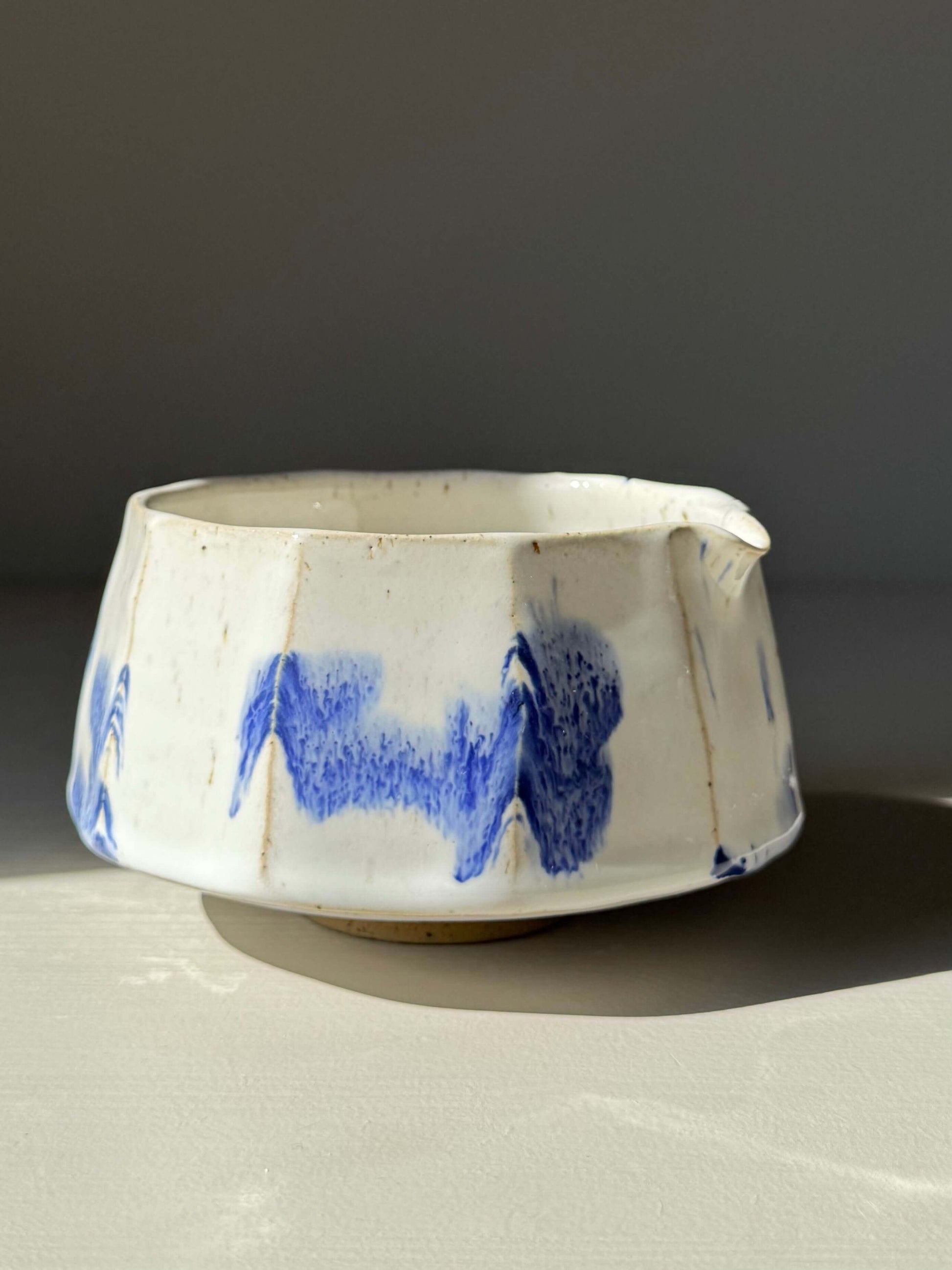 Handmade ceramic Faceted Matcha Bowl with Spout – Cobalt Blue & Glossy White Glaze #06, featuring bold hand-splashed blue accents.
