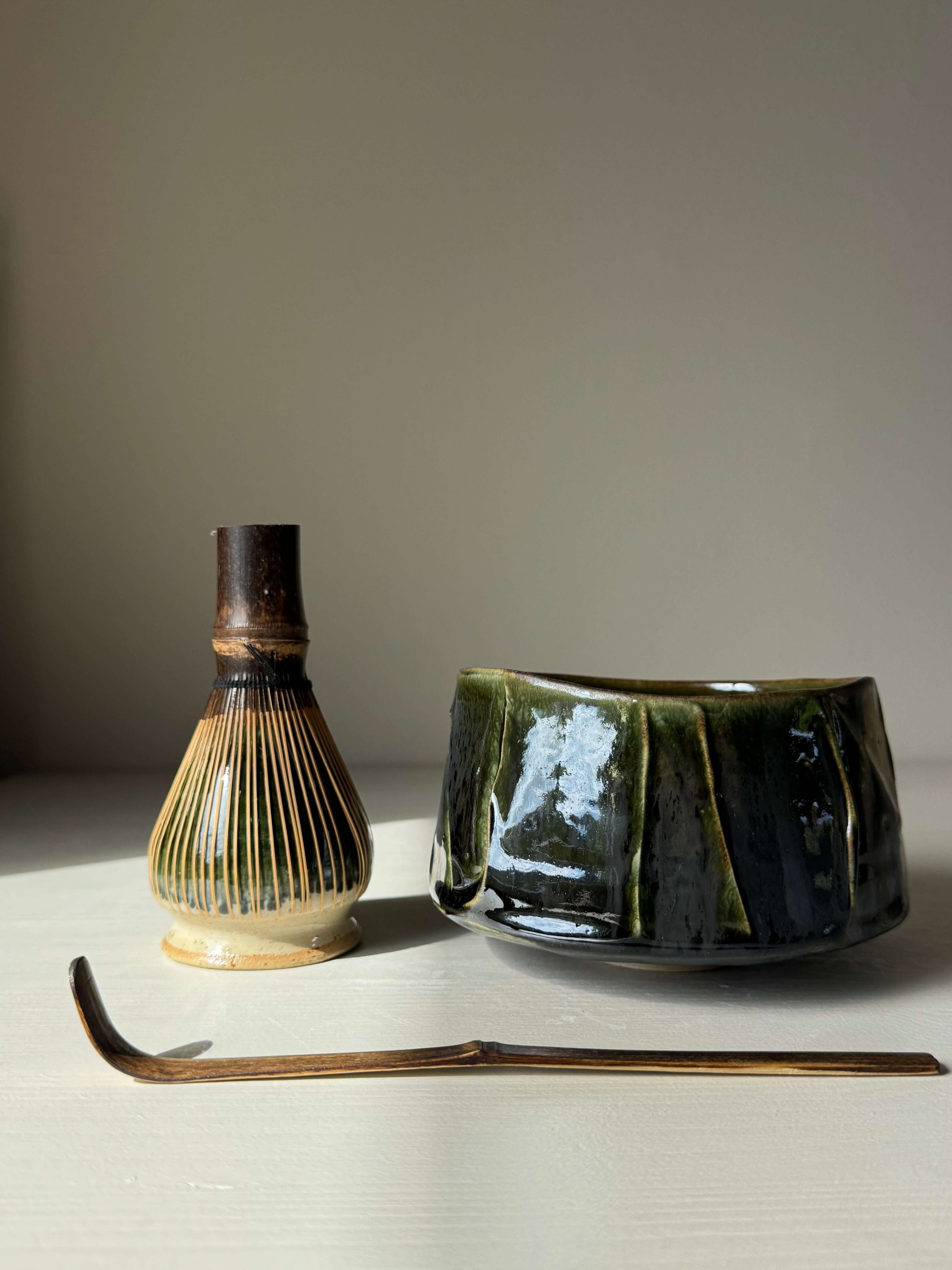 Textured Matcha Bowl - Hinoki Series #10 with handmade ceramic, featuring green glaze and textured finish, next to a bamboo whisk and scoop.