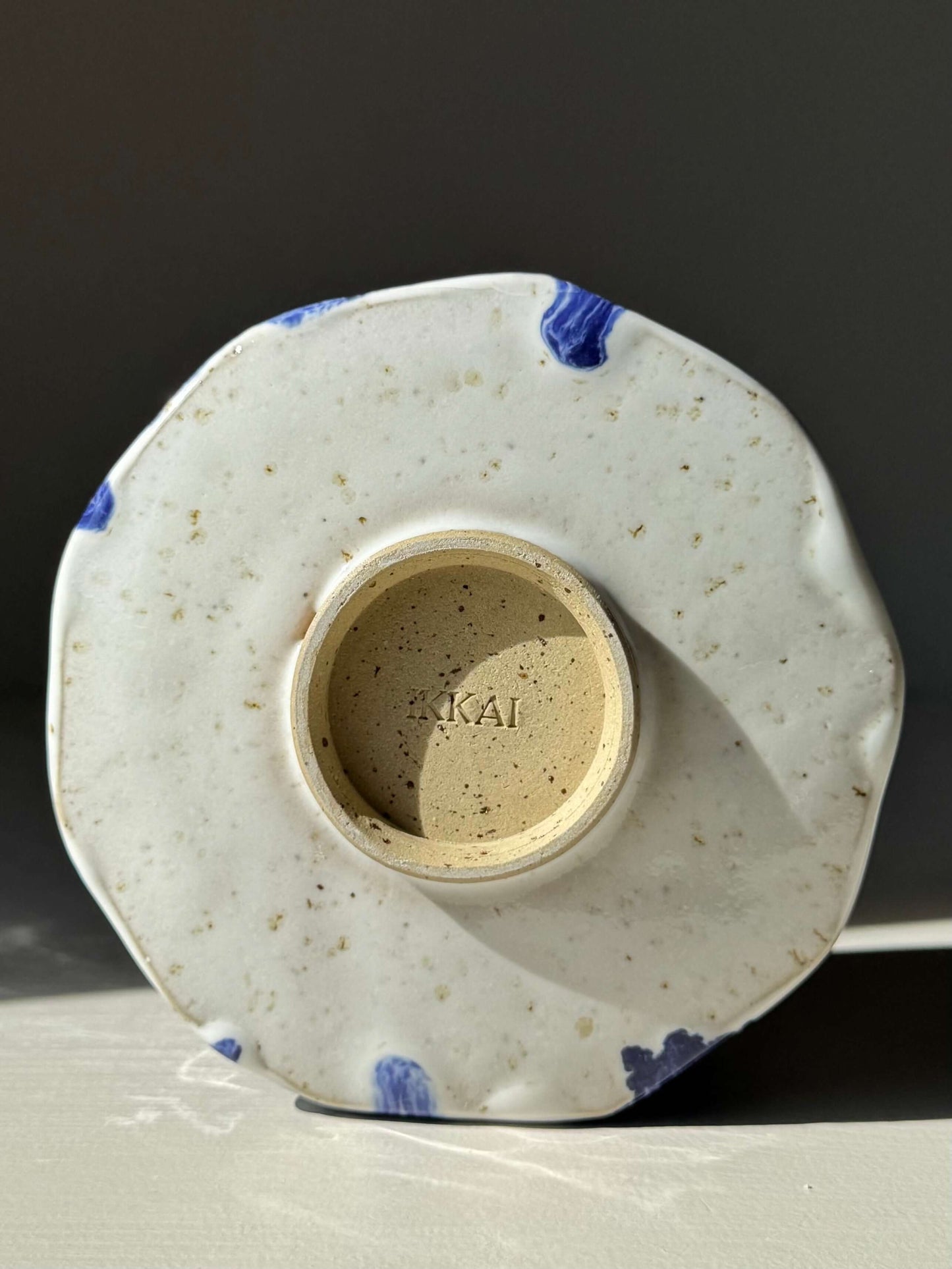 Base view of Faceted Matcha Bowl with Spout – Cobalt Blue & Glossy White Glaze #03, showcasing handmade ceramic details and blue accents.
