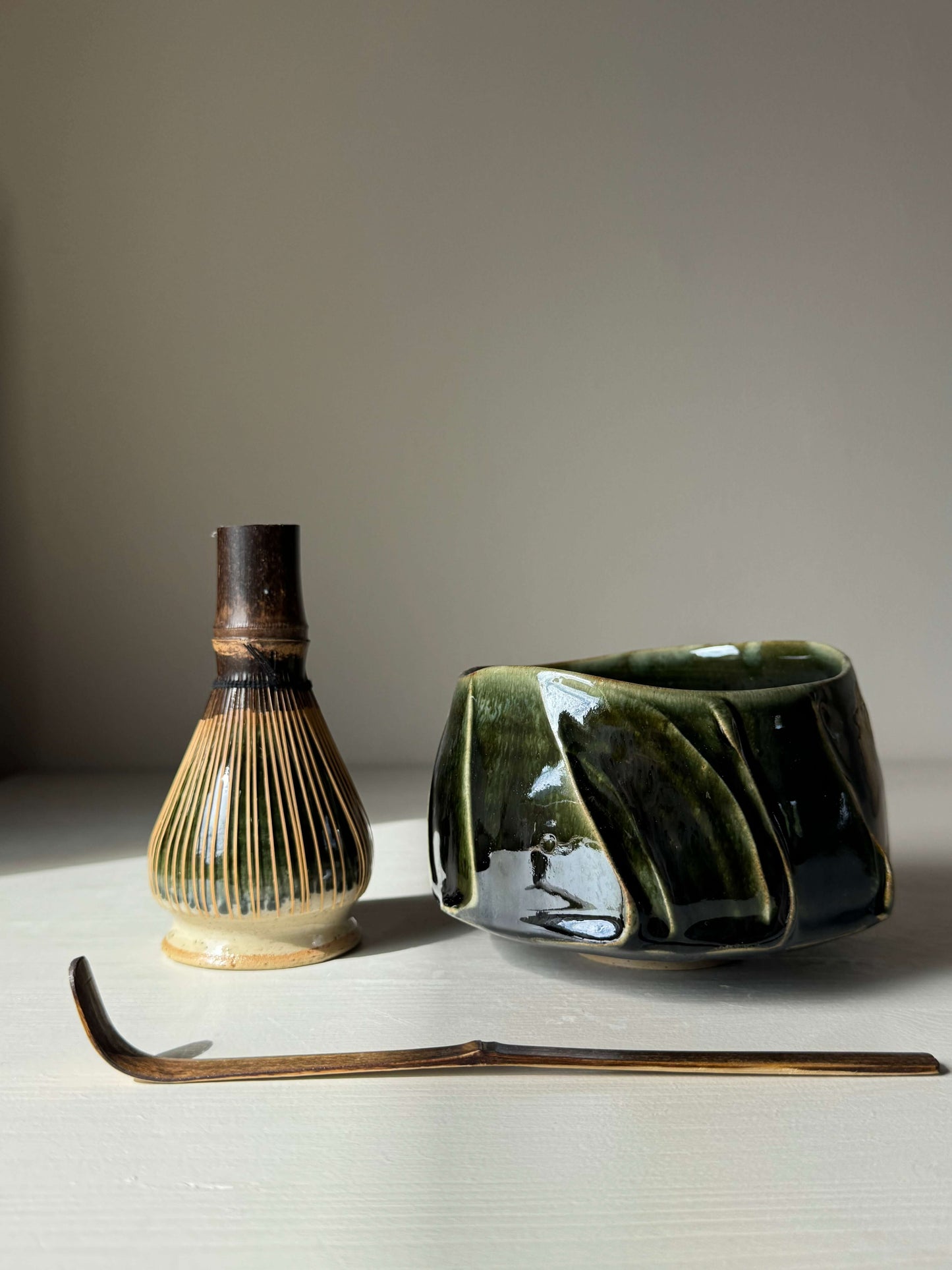 Handmade ceramic Textured Matcha Bowl - Hinoki Series #09 with matcha whisk and scoop, featuring calming green hues and textured finish.