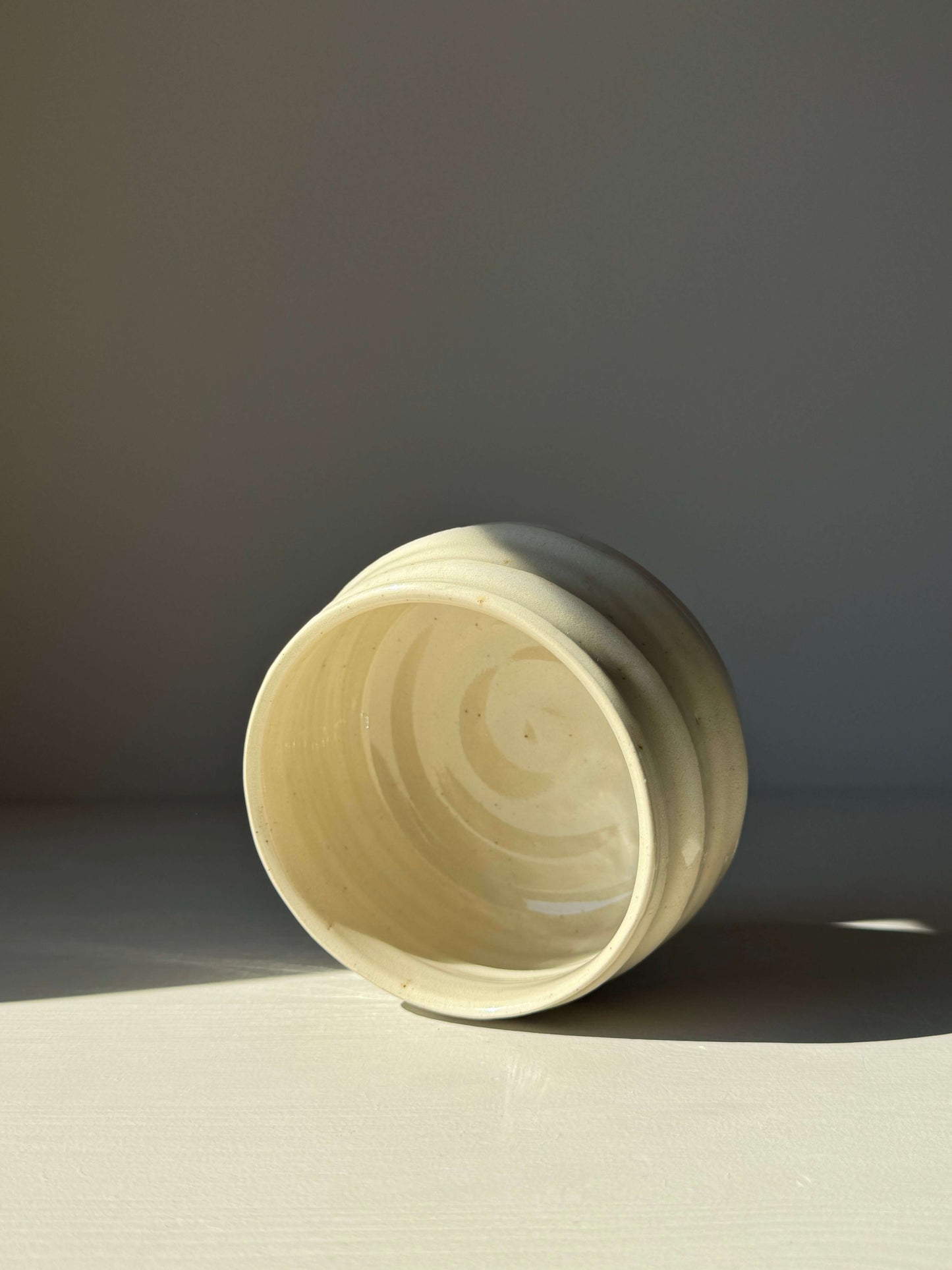 Textured rounded matcha bowl with clear glaze highlighting natural stoneware beauty and unique subtle textures.
