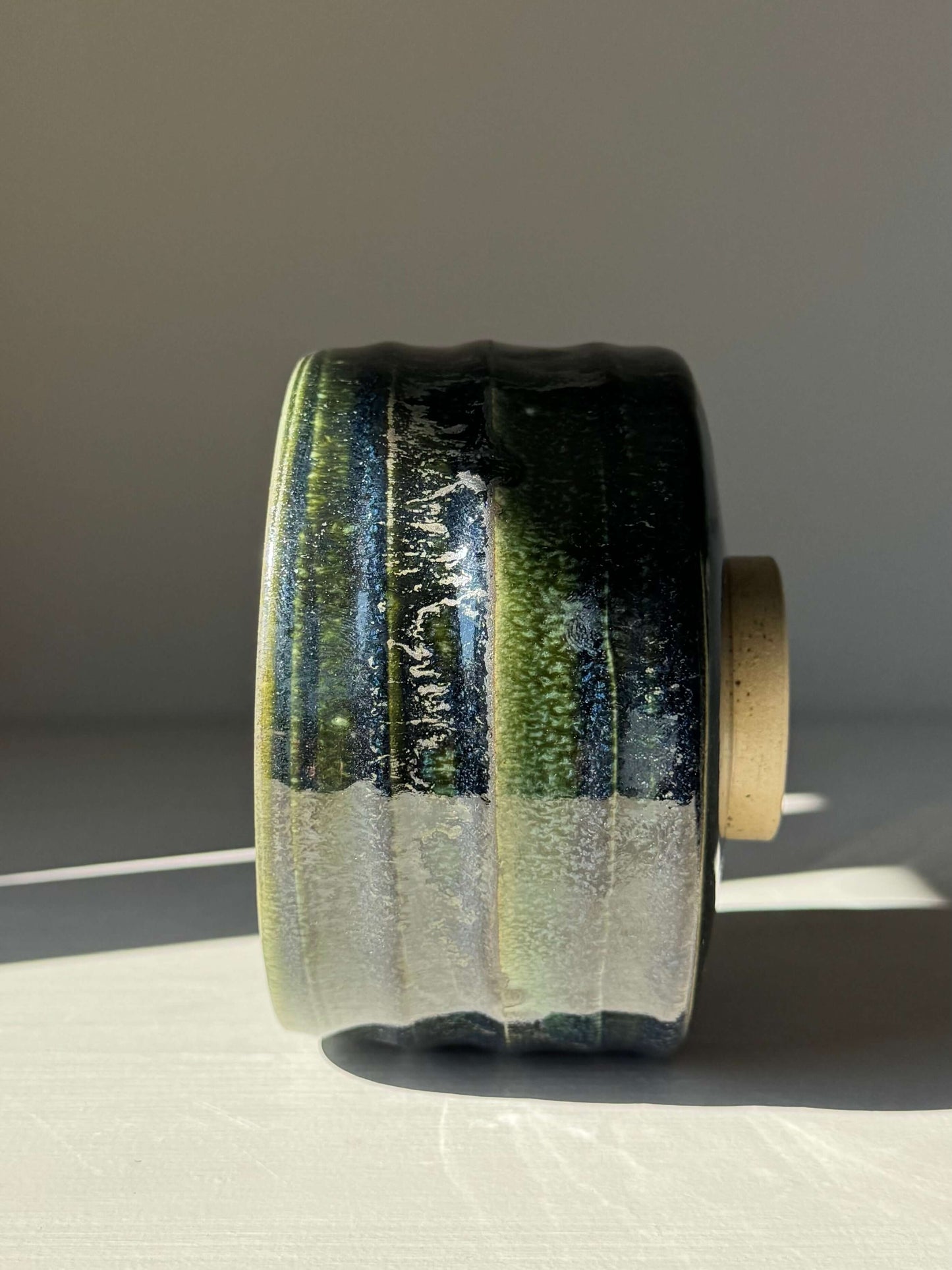Side view of handmade ceramic Textured Matcha Bowl - Hinoki Series #04 with green glaze and textured finish.