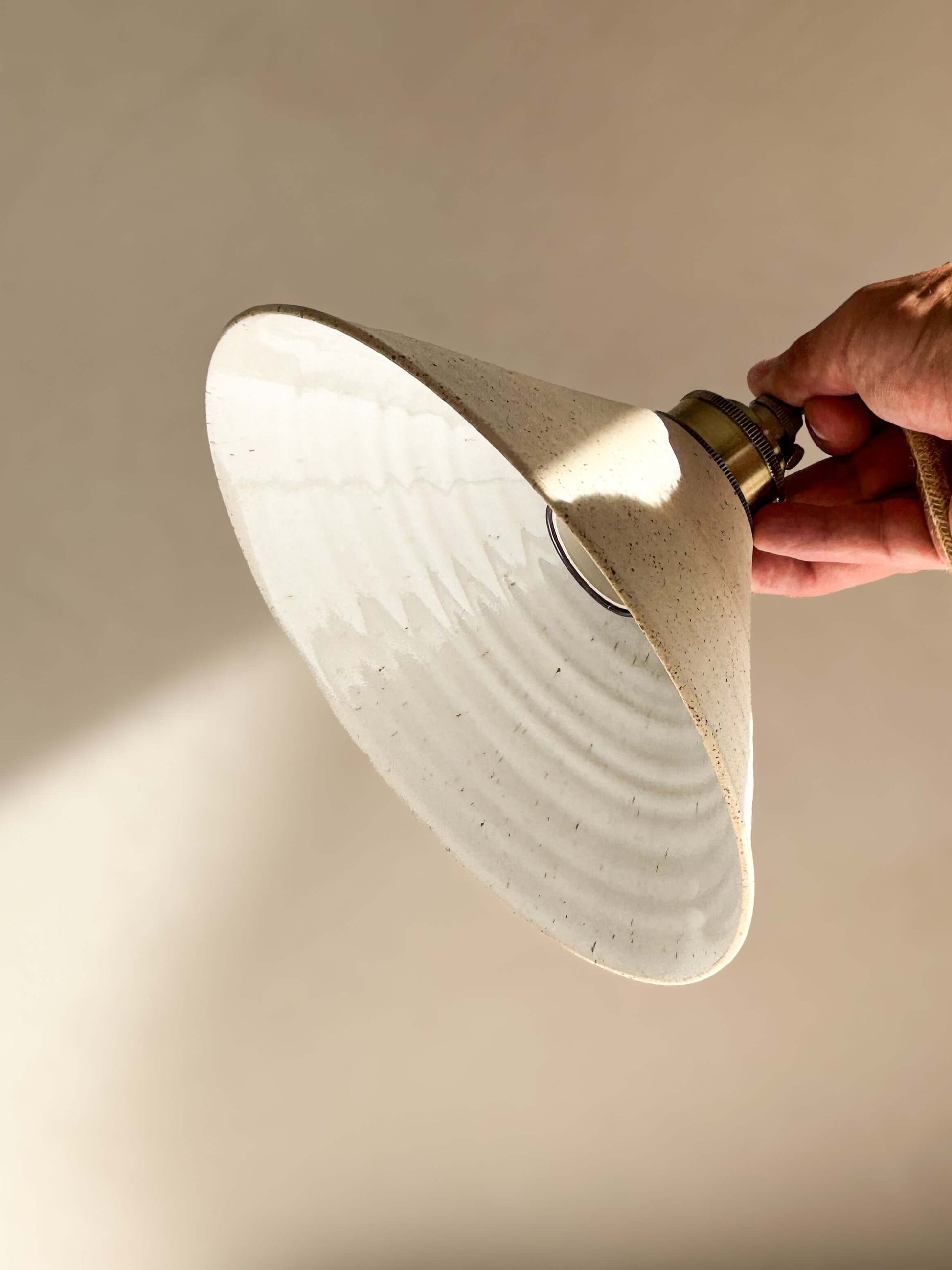 Handmade Ceramic Lamp Shade – Half Glossy White Glaze with raw unglazed exterior, reflecting bright soft light.