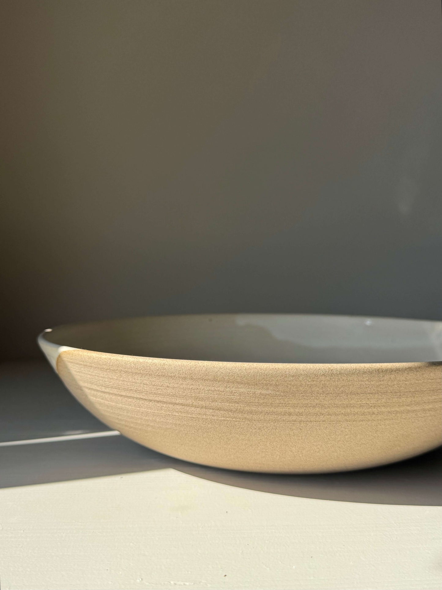 Handmade ceramic Large Shallow Bowl - Yuki Series with white glaze, showcasing subtle, sculptural design perfect for shared meals.