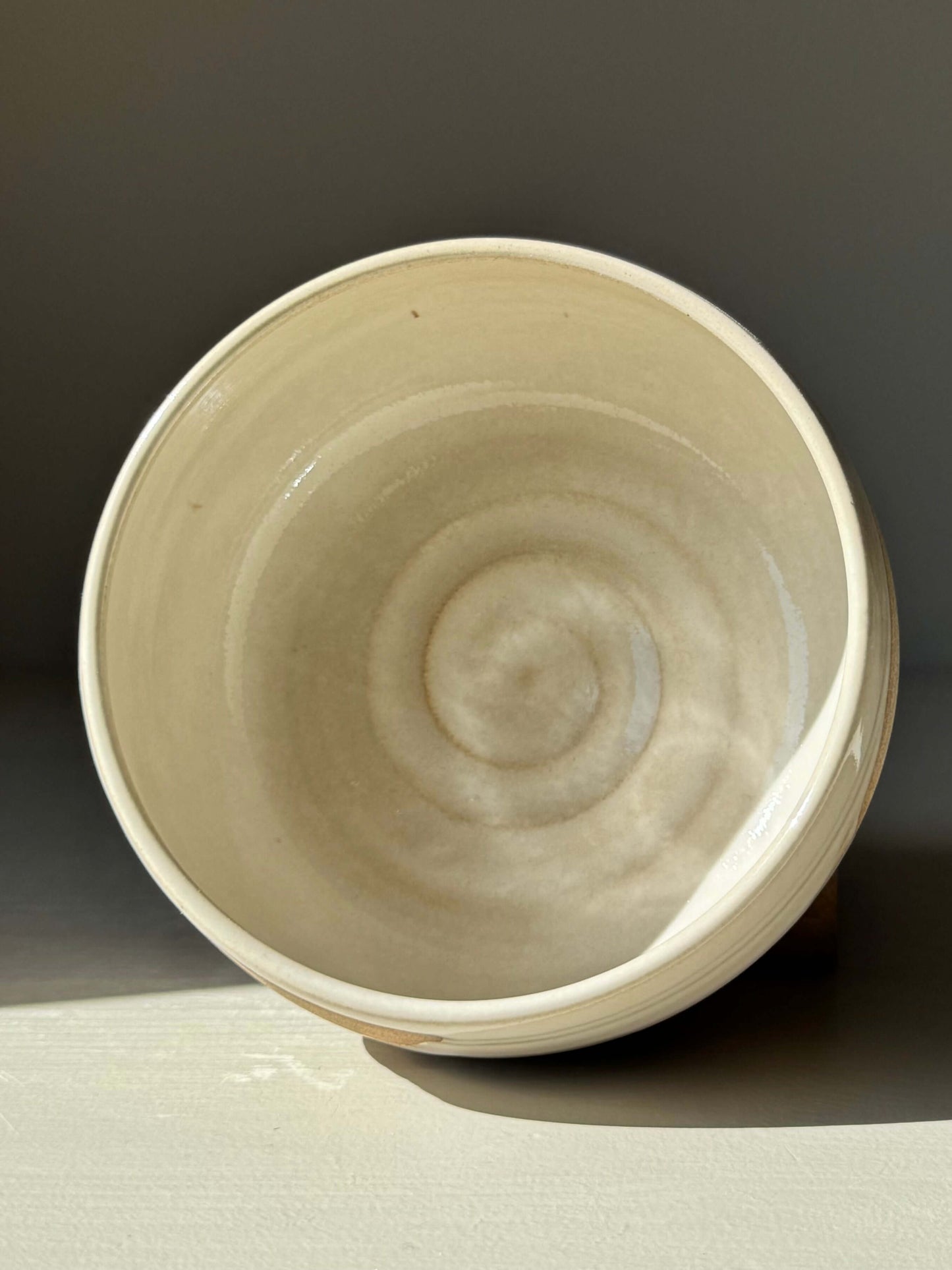 Handmade ceramic Matcha Bowl – Yuki Series #01 with glossy white glaze, showcasing unique wheel-thrown design and natural patterns.