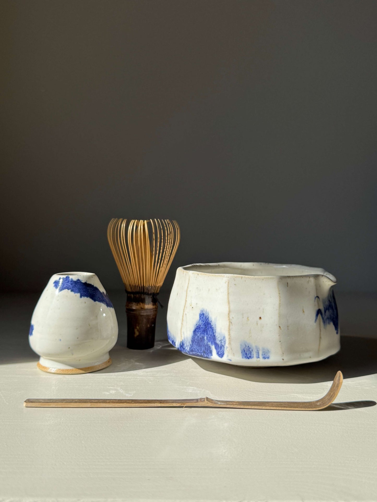 Faceted Matcha Bowl with Spout – Cobalt Blue & Glossy White Glaze #05, handmade ceramic with unique textured facets and vibrant blue accents.