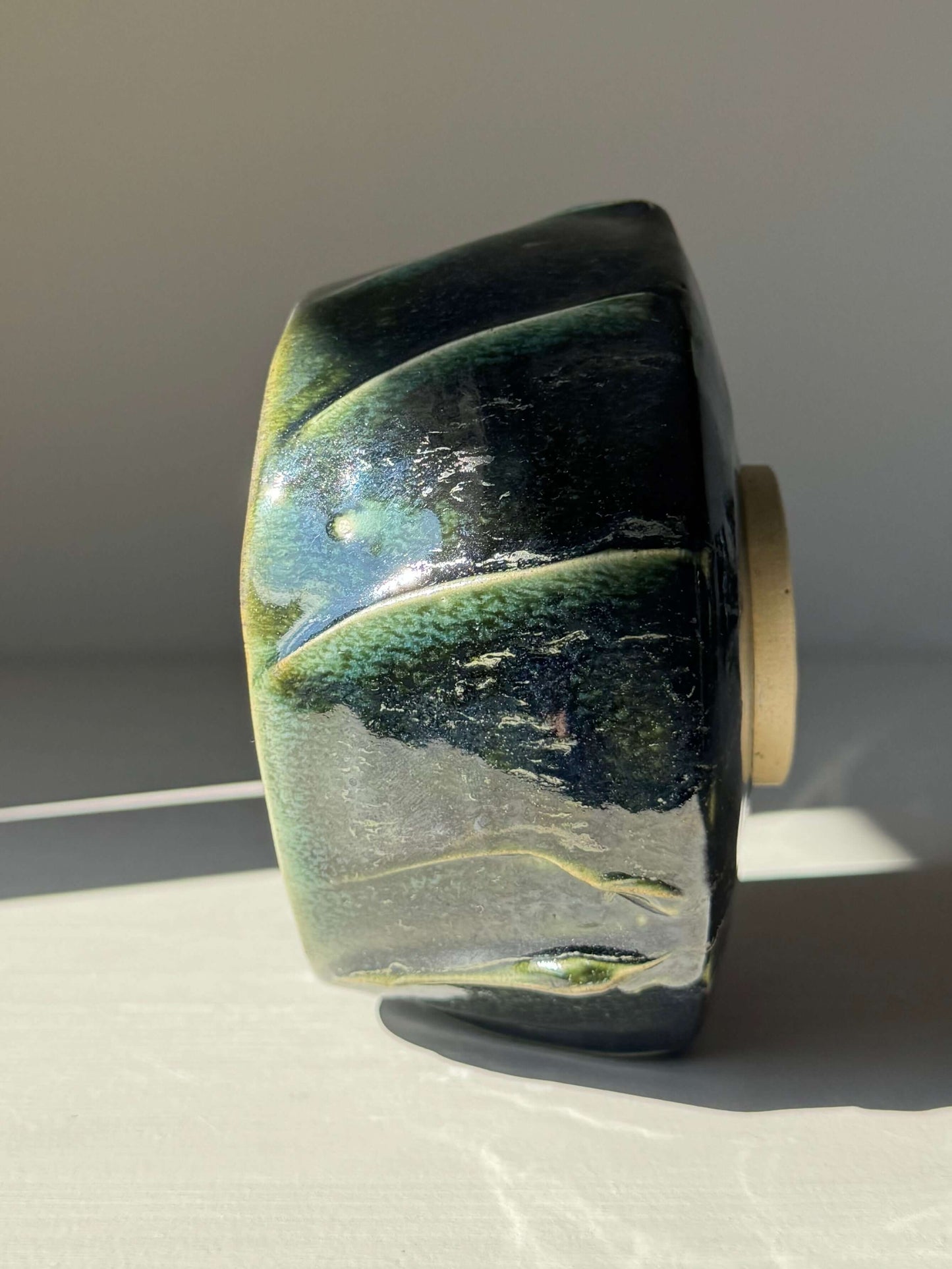 Side view of the handmade ceramic Textured Matcha Bowl - Hinoki Series #03, showcasing its unique green glaze and textured finish.