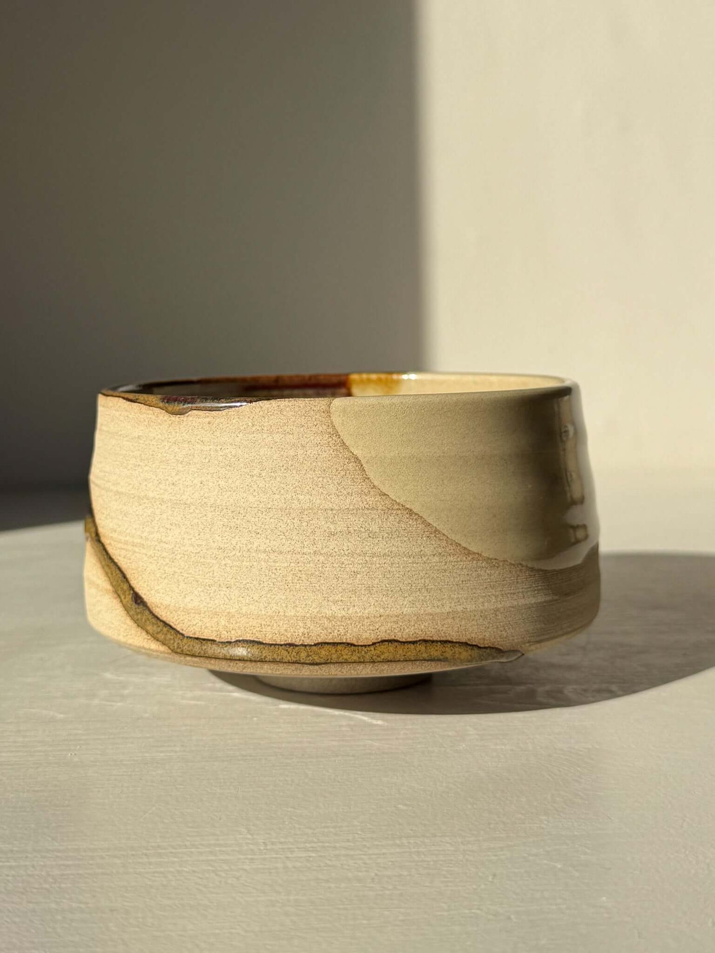 Matcha Bowl – Inyo #07 showcasing unique glazes on warm stoneware clay, hand-thrown and glazed in a home studio.