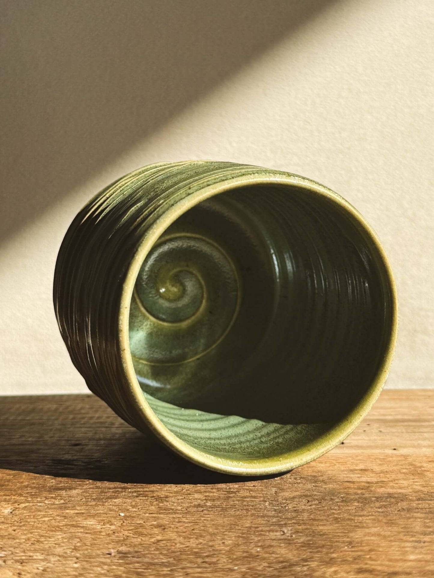 Wasabi Green Yunomi Cup #02 with textured spiral interior, showcasing layered slip and subtle shine, perfect for 300ml of tea.