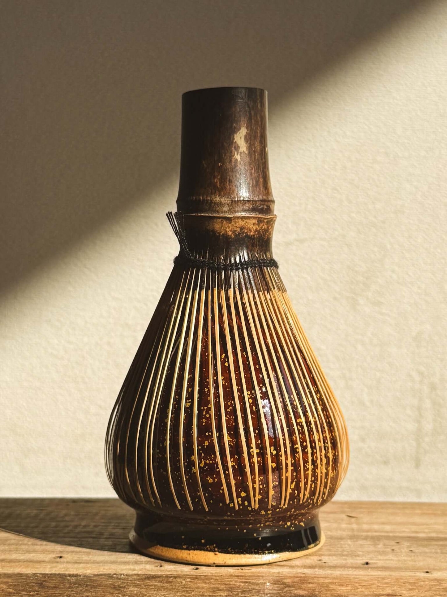 Amber glazed matcha whisk holder for bamboo Chasen, enhancing tea setup aesthetics and prolonging whisk longevity.