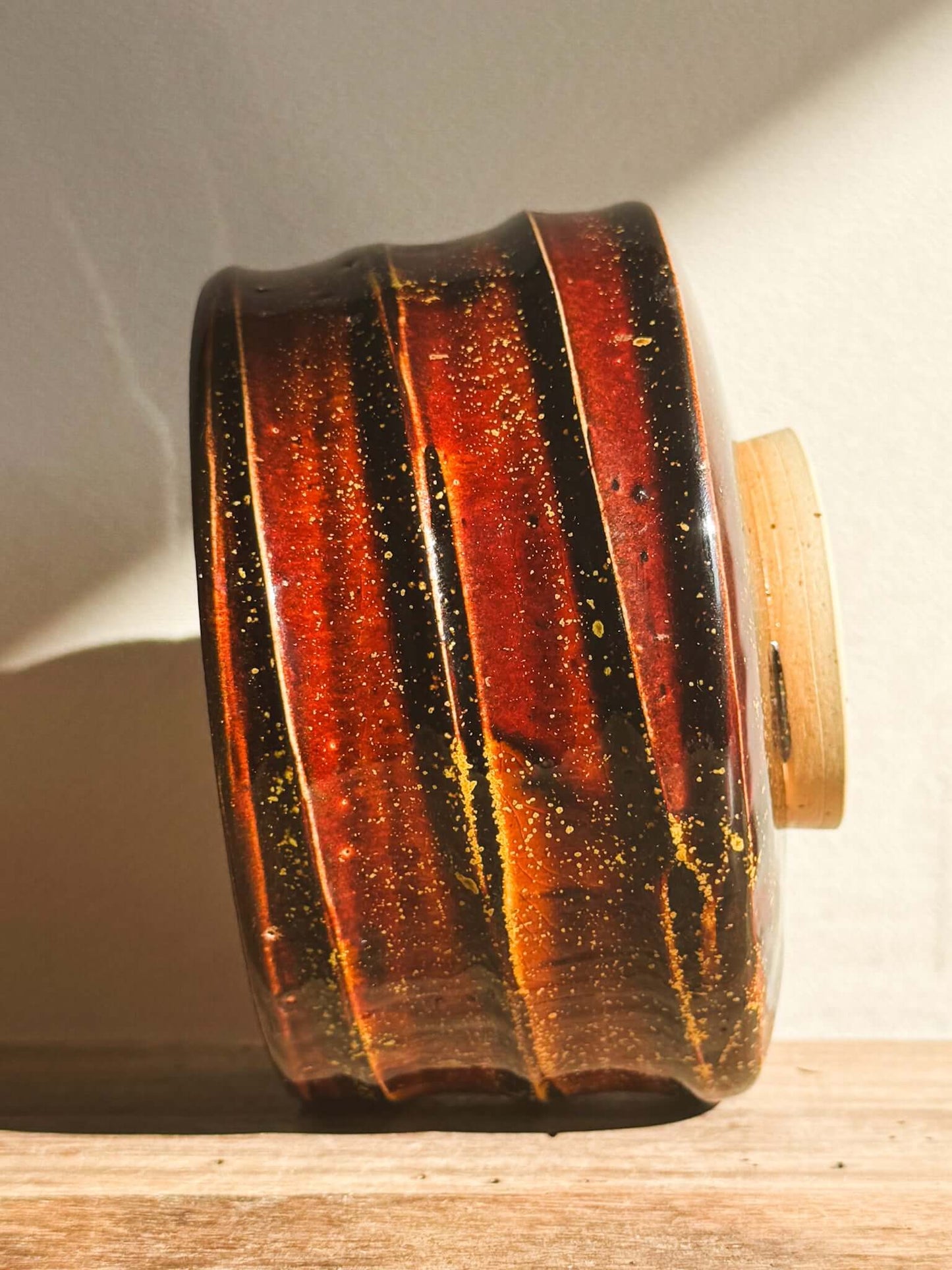 Kinsei Matcha Bowl #05 with earthy amber and rust tones, swirling bands, and light-reflecting glaze, capturing autumn sunlight.