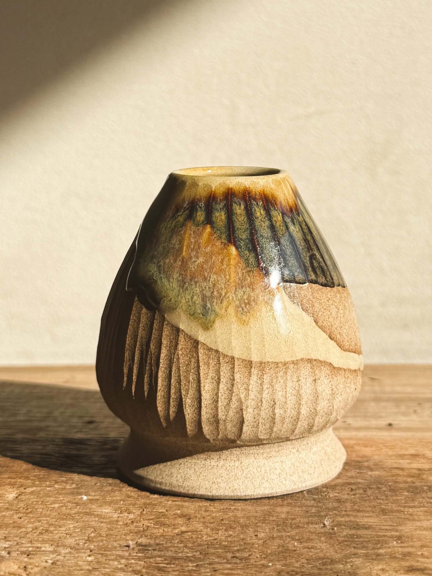 Handcrafted Matcha whisk holder from the Inyo Series, displaying textural contrasts with raw clay and glossy glaze. Artisanal pottery.