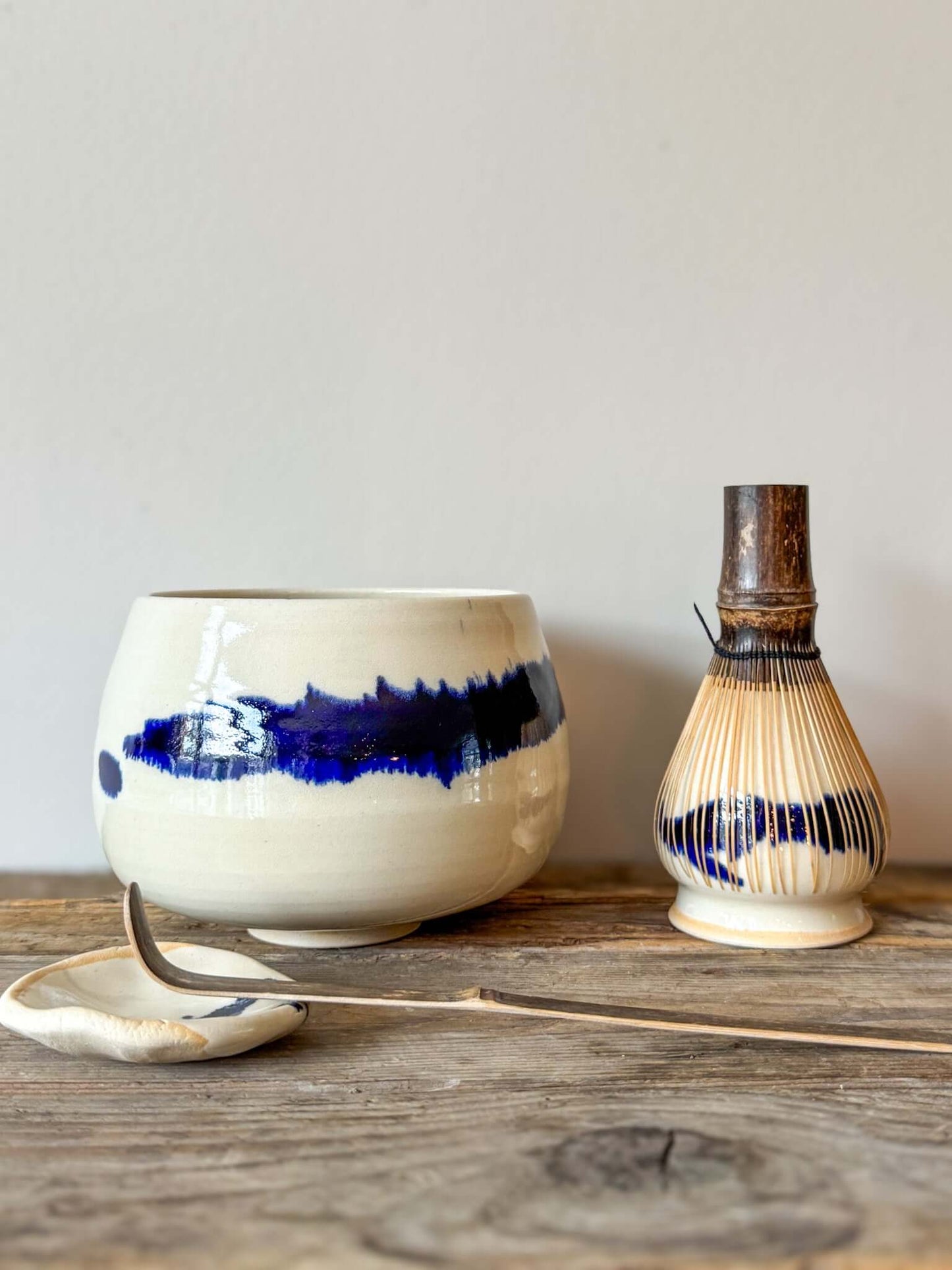 Large Rounded Matcha Bowl with cobalt glaze from Gosu Series #02 displayed on rustic wood table.