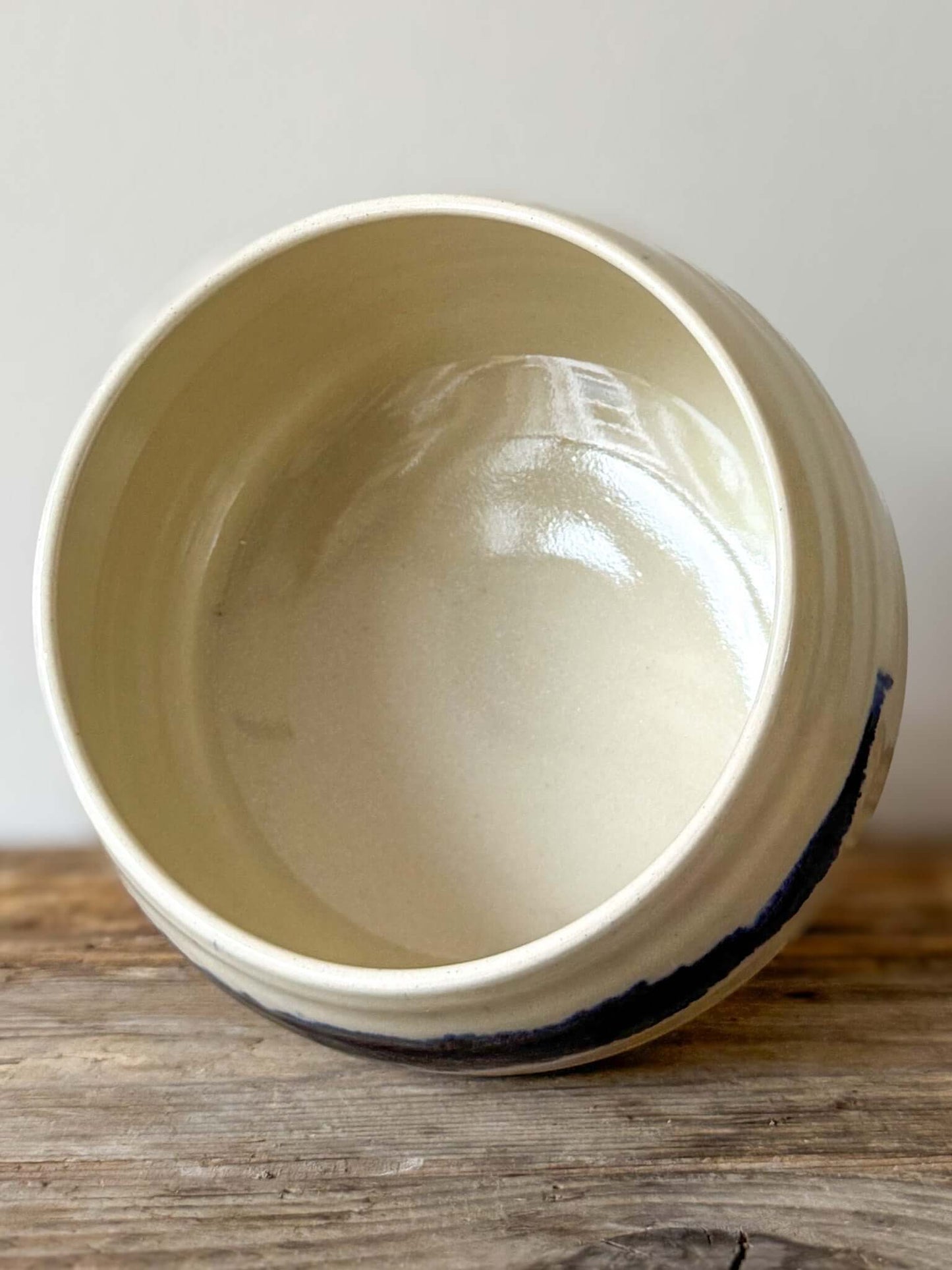 Large Rounded Matcha Bowl with cobalt glaze, part of Gosu Series #02, showcasing soft curves and dramatic blue band, on wood surface.
