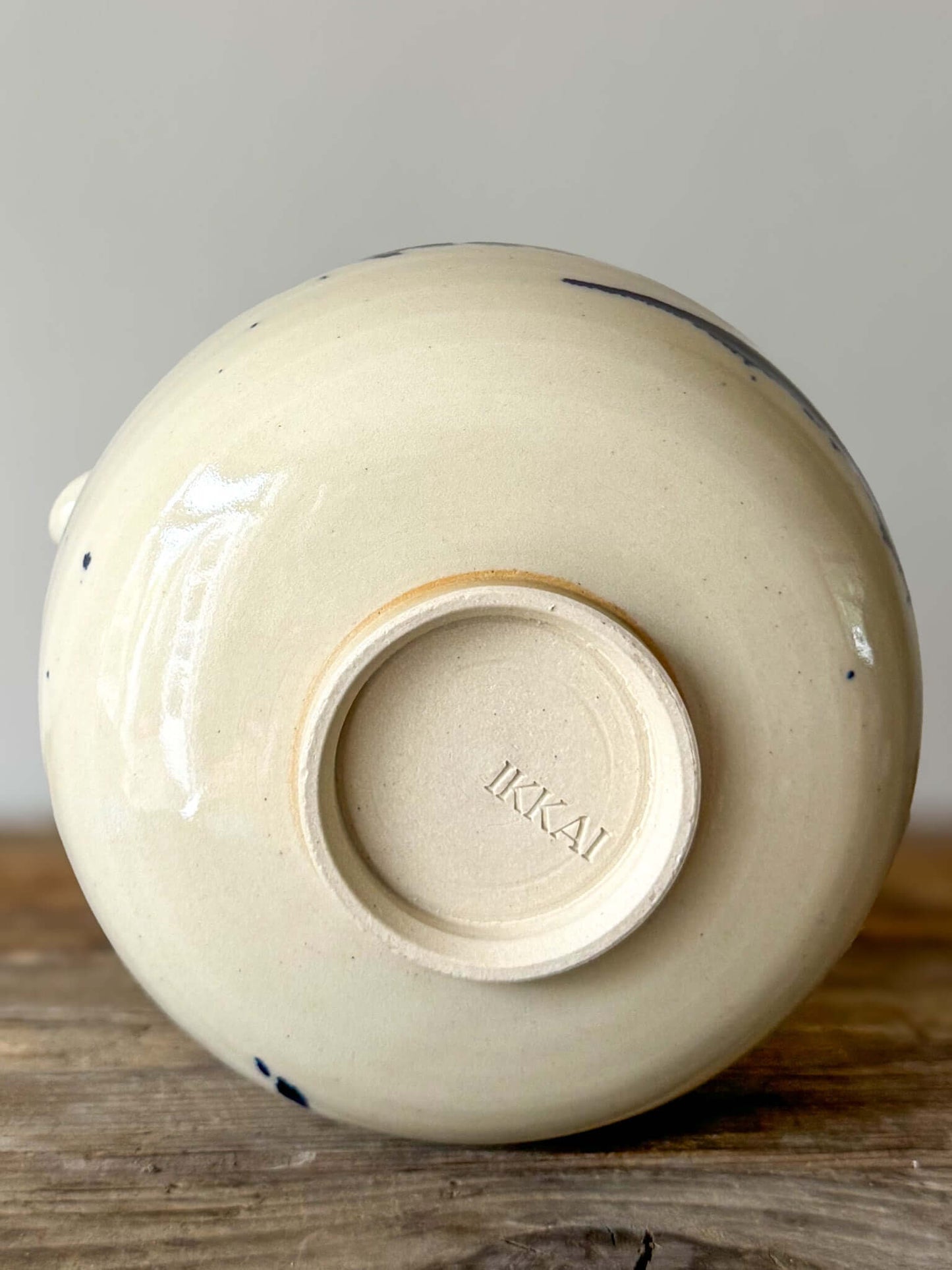 Underside view of Katakuchi Matcha Bowl with spout from Gosu Series, showcasing maker's stamp.