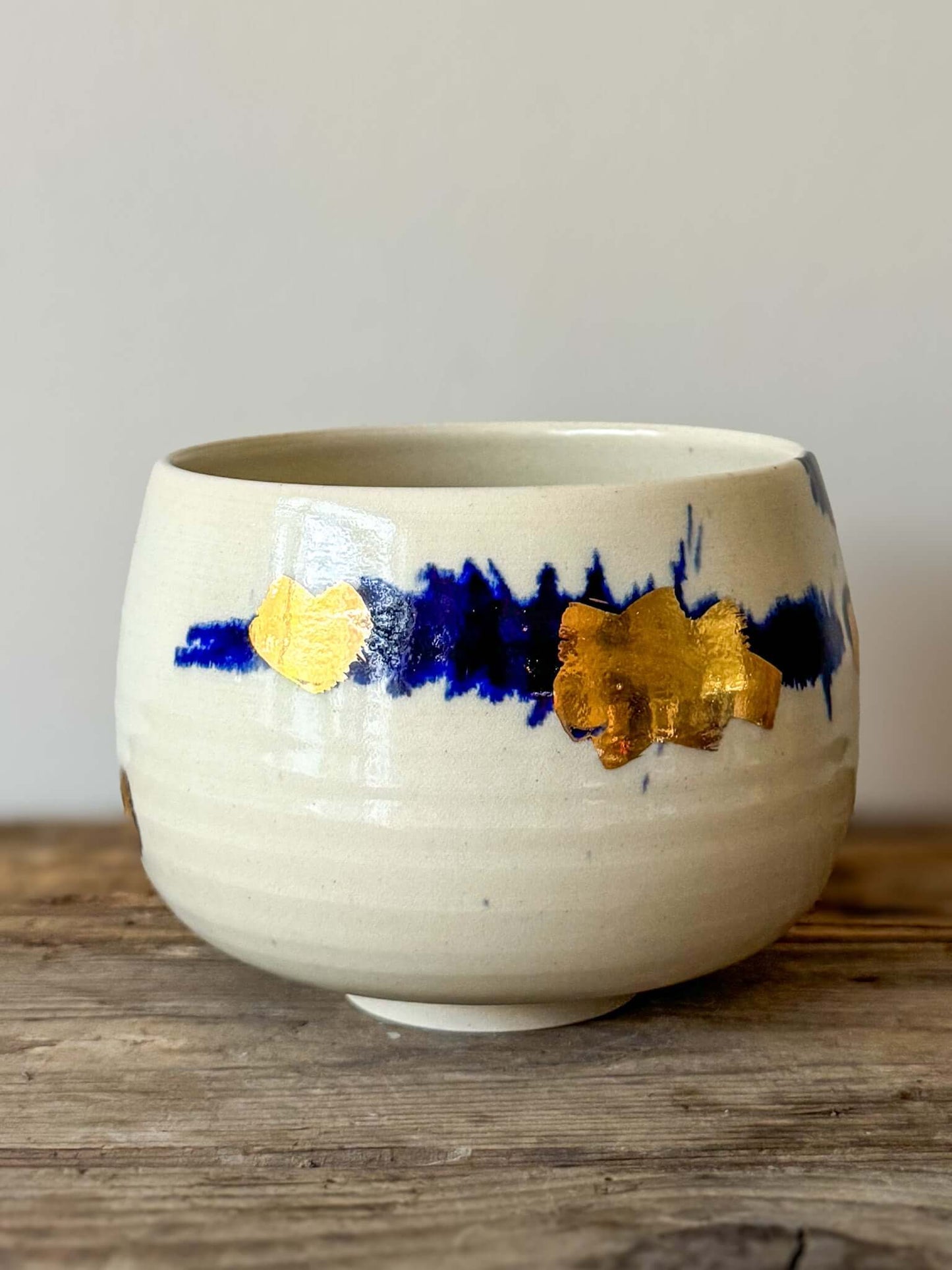 Rounded Matcha Bowl from Gosu Series with cobalt glaze and gold leaf accents, creating a serene and bold artistic contrast.