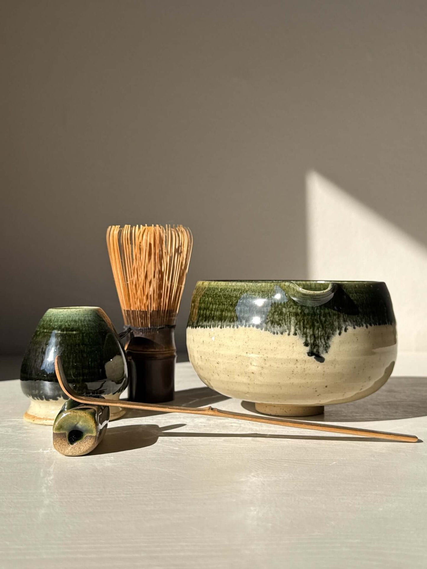 Matcha Bowl with Spout - Green Rim #06, traditional Katakuchi bowl, matcha whisk and tools on table.