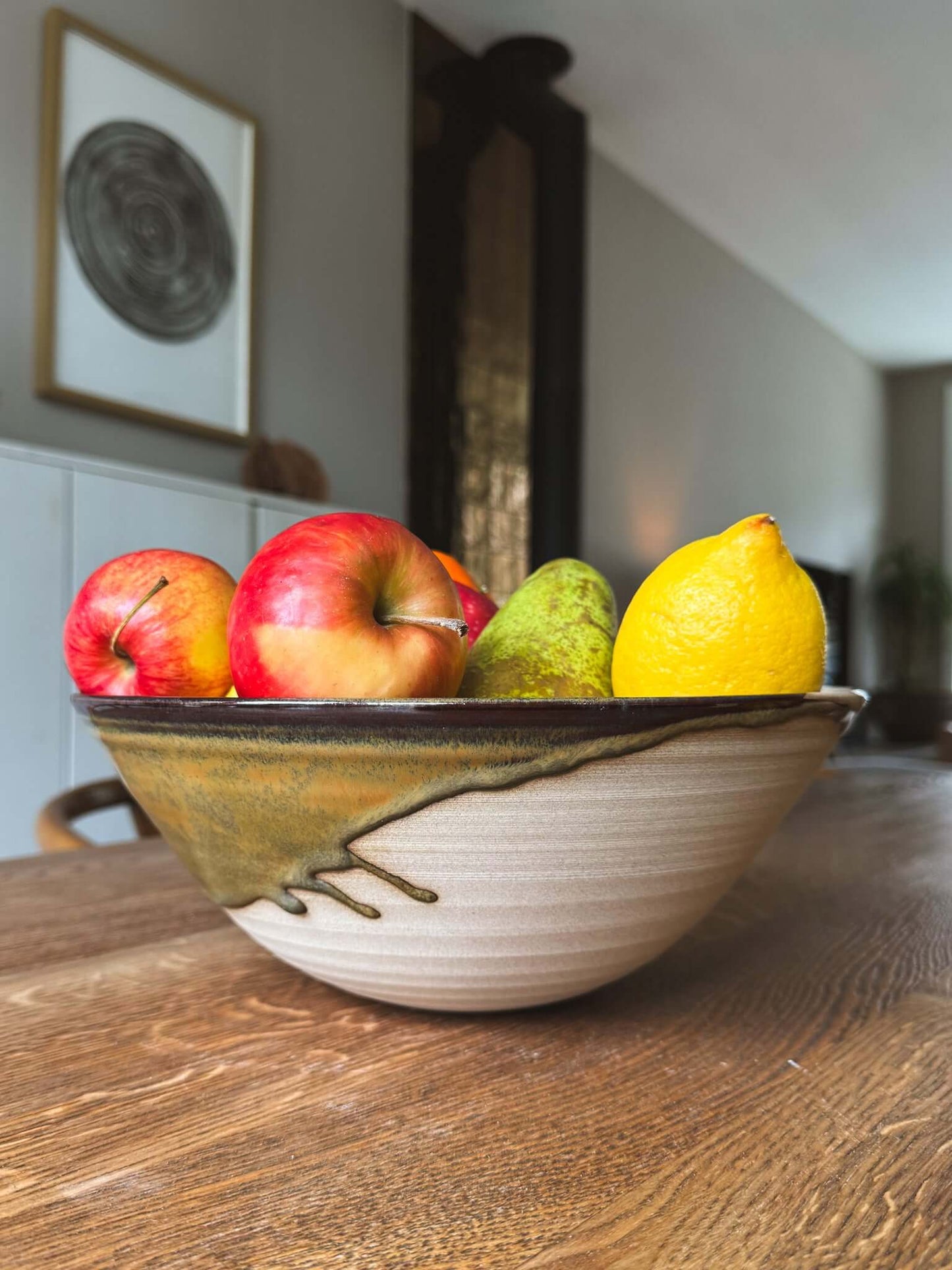 Large Bowl - Inyo #04 filled with colorful apples, pears, and a lemon on a wooden table.