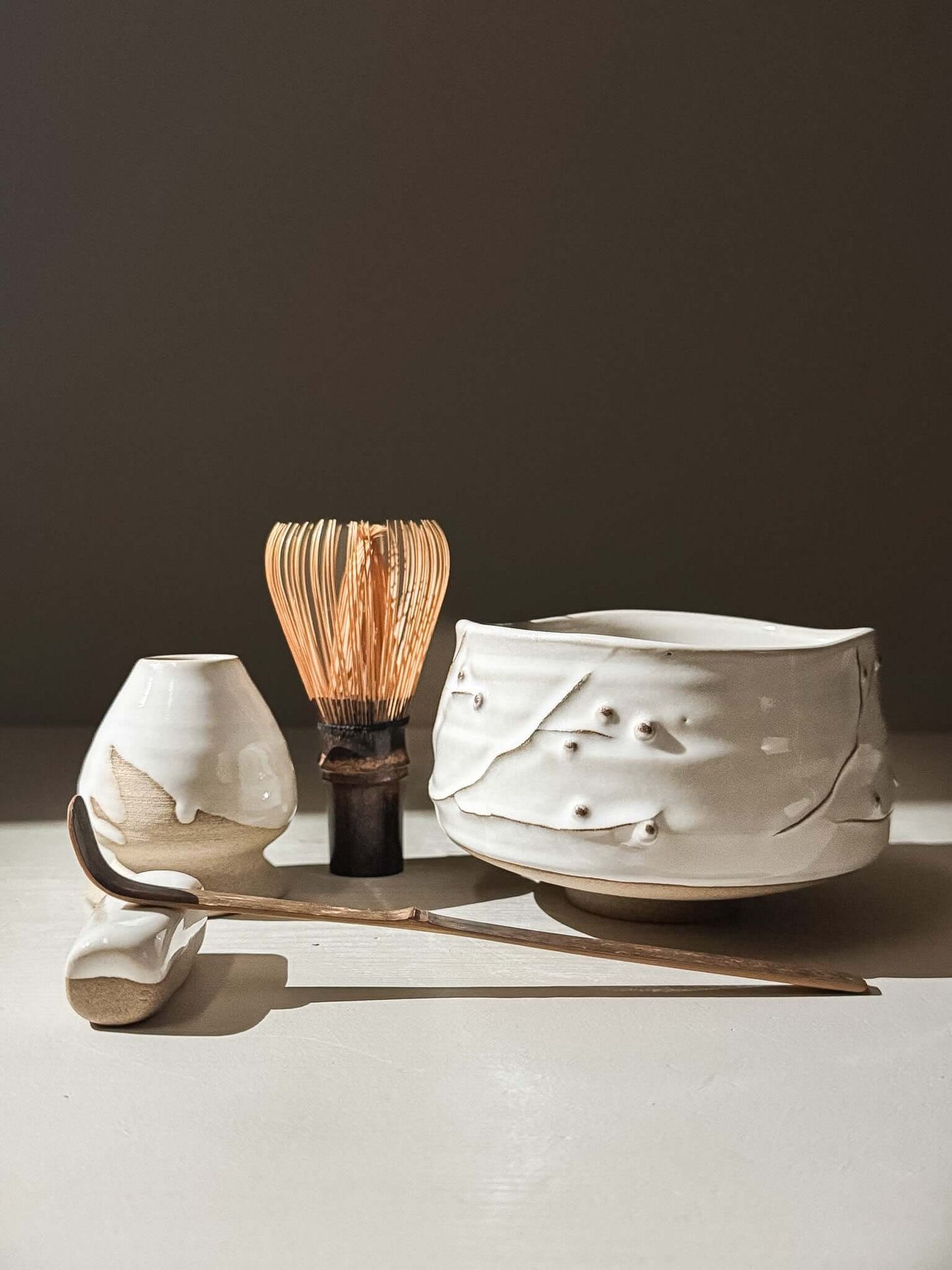 Matcha Bowl – Yuki Branches #01 with ivory glaze, bamboo whisk, and accessories on a neutral background.