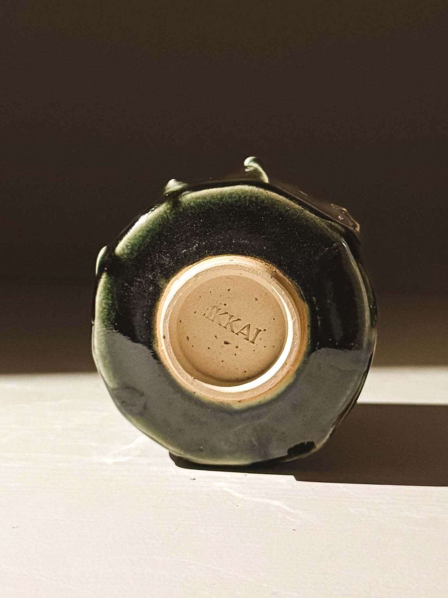 Bottom view of a handcrafted Yunomi Cup - Hinoki #03 with deep green glaze detail.