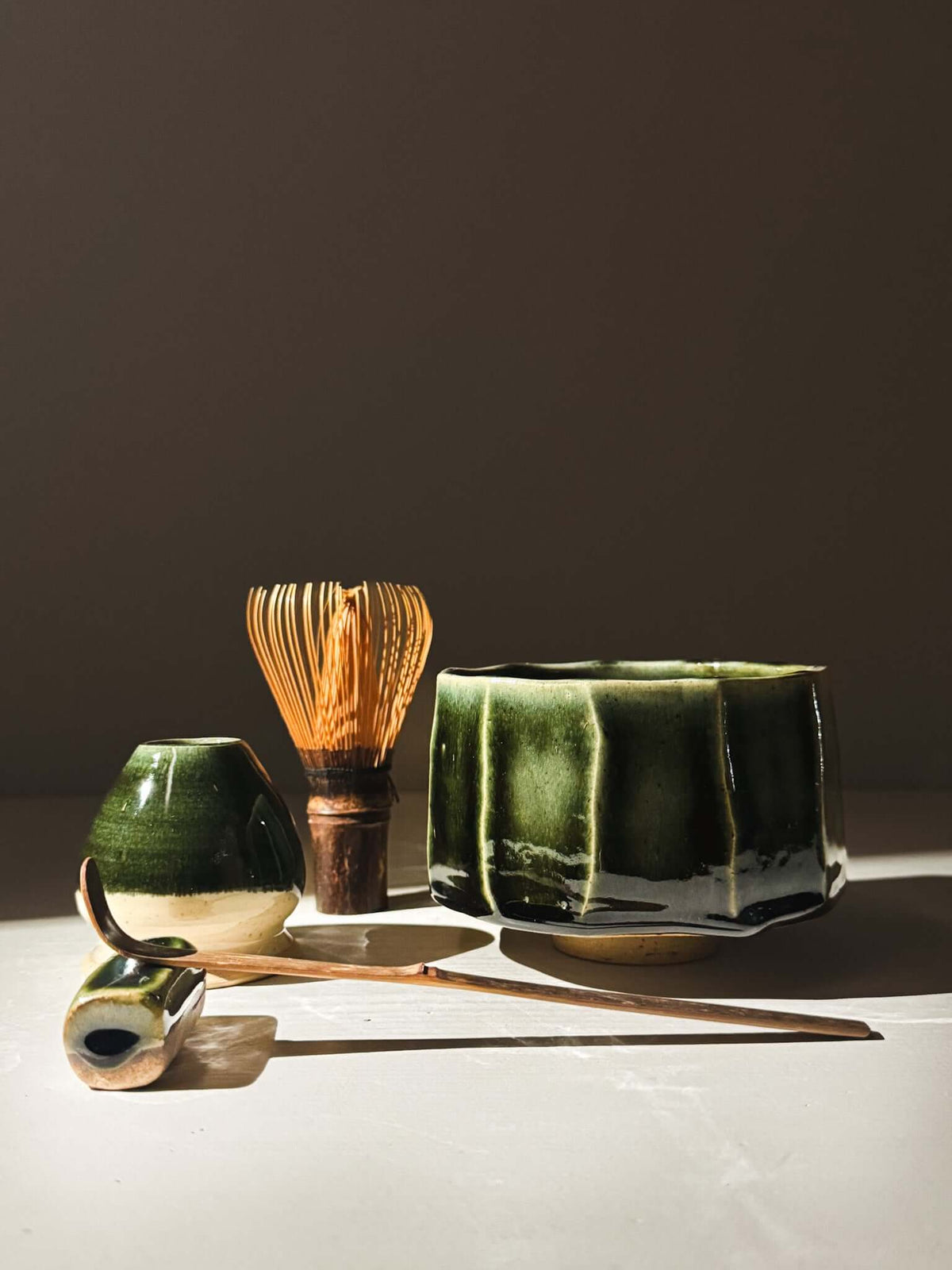 Faceted Matcha Bowl - Hinoki #01 with rich green glaze and matcha accessories in natural light
