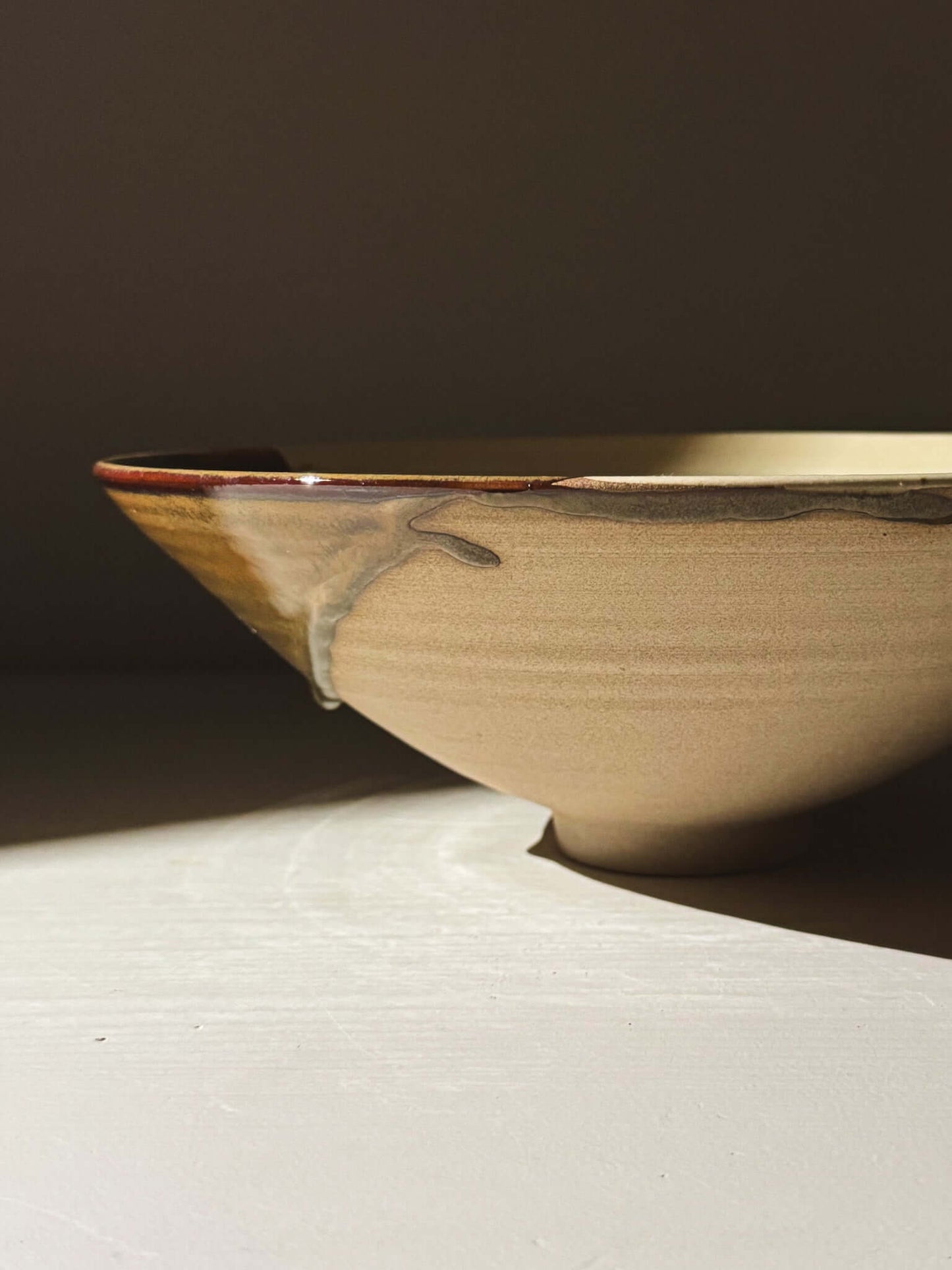 Medium Bowl - Inyo #02 with tenmoku browns, golden tones, and a subtle pool of green, featuring unique glaze drips and variations.