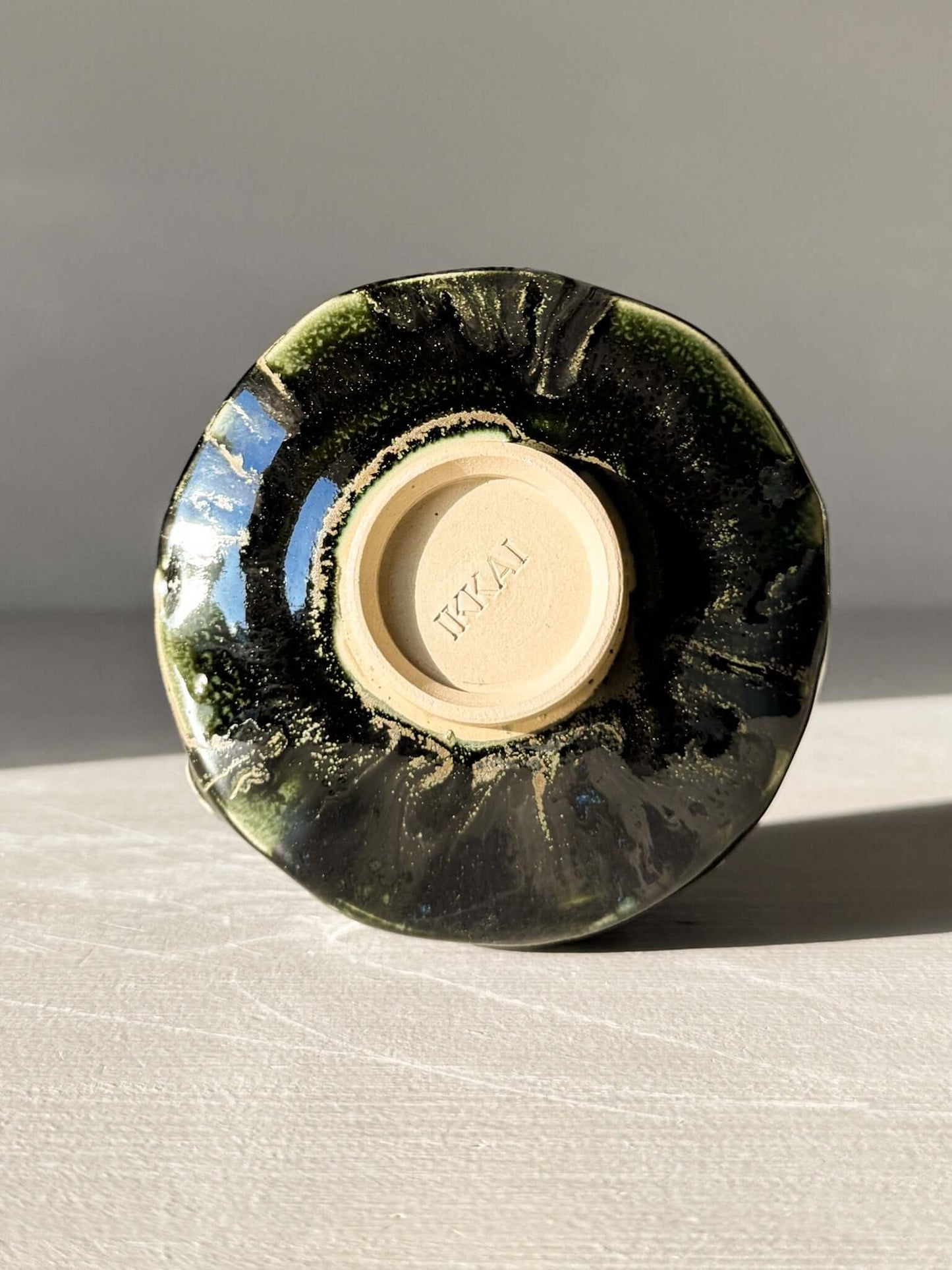 Bottom view of Yunomi Cup - Hinoki #02 with deep green glaze and handmade texture