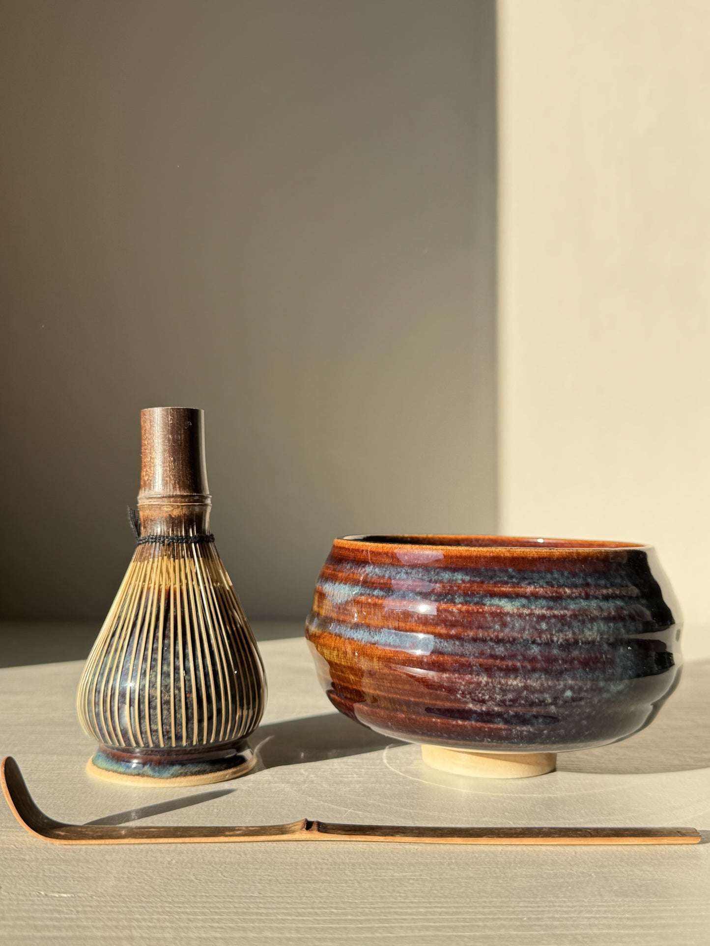 Matcha Bowl - Glossy Blue #01 with whisk and scoop in warm light.