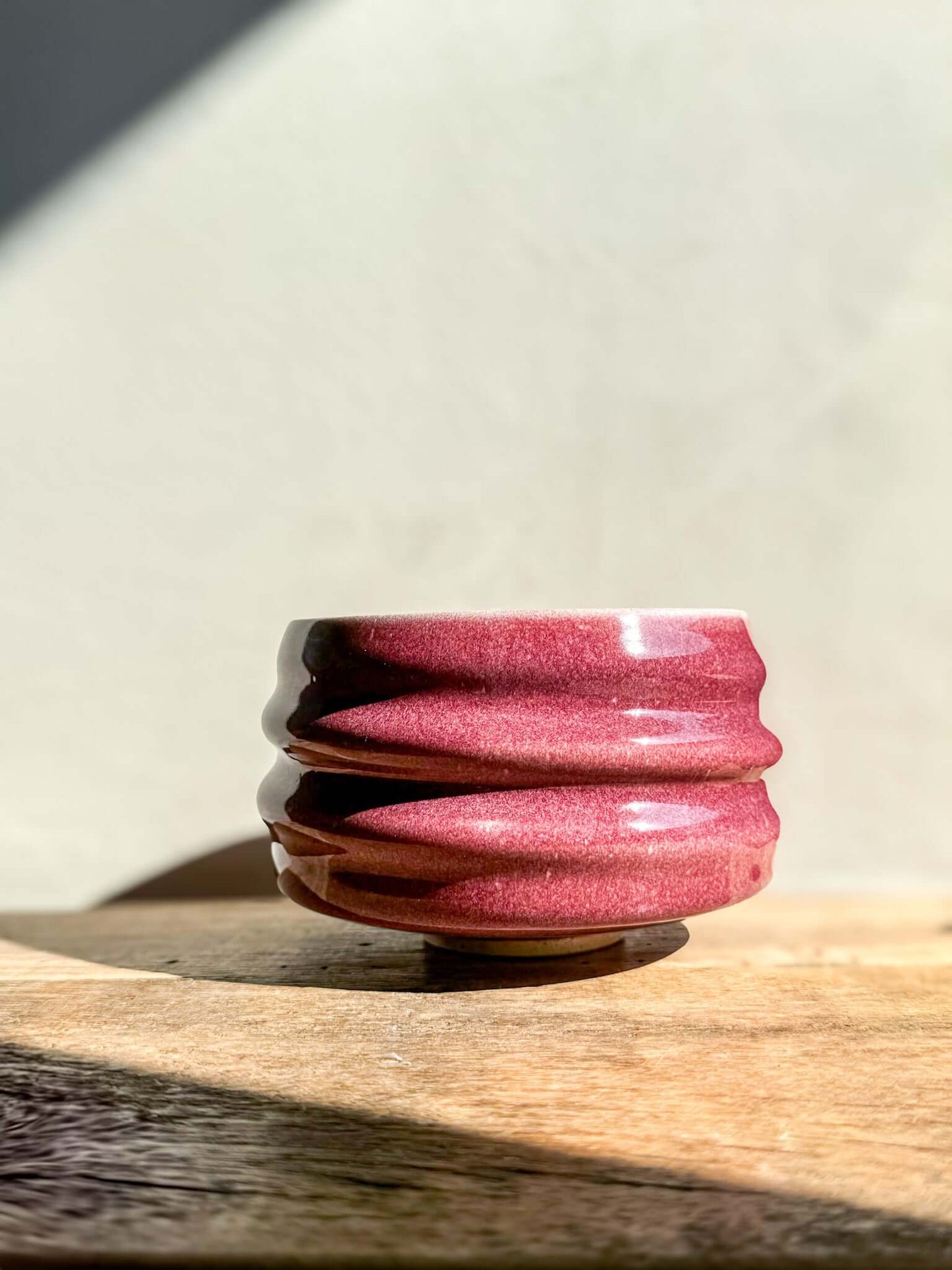 Ume Series Matcha Bowl in pink with sculptural ridges, inspired by Japanese Ume blossom, symbolizing beauty and resilience.