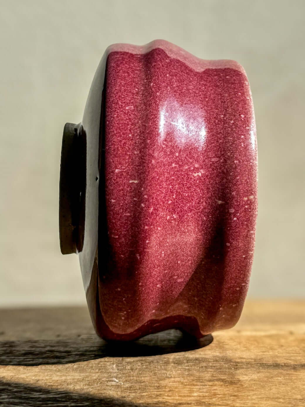 Side view of red Matcha Bowl from Ume Series #05 with sculptural ridges, inspired by Japanese Ume blossom, symbolizing renewal.