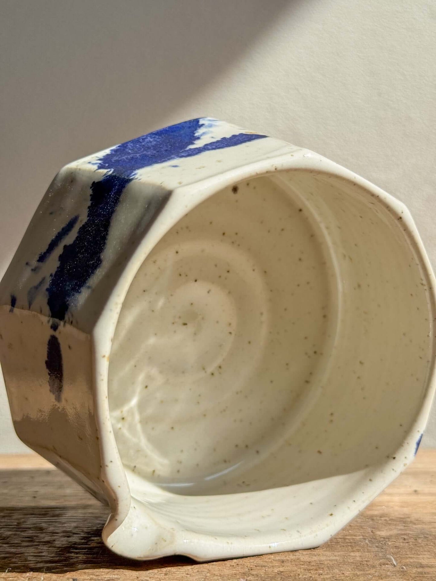 Faceted Matcha Bowl with Spout in Cobalt Blue and Glossy White Glaze, showcasing textured details and modern design.