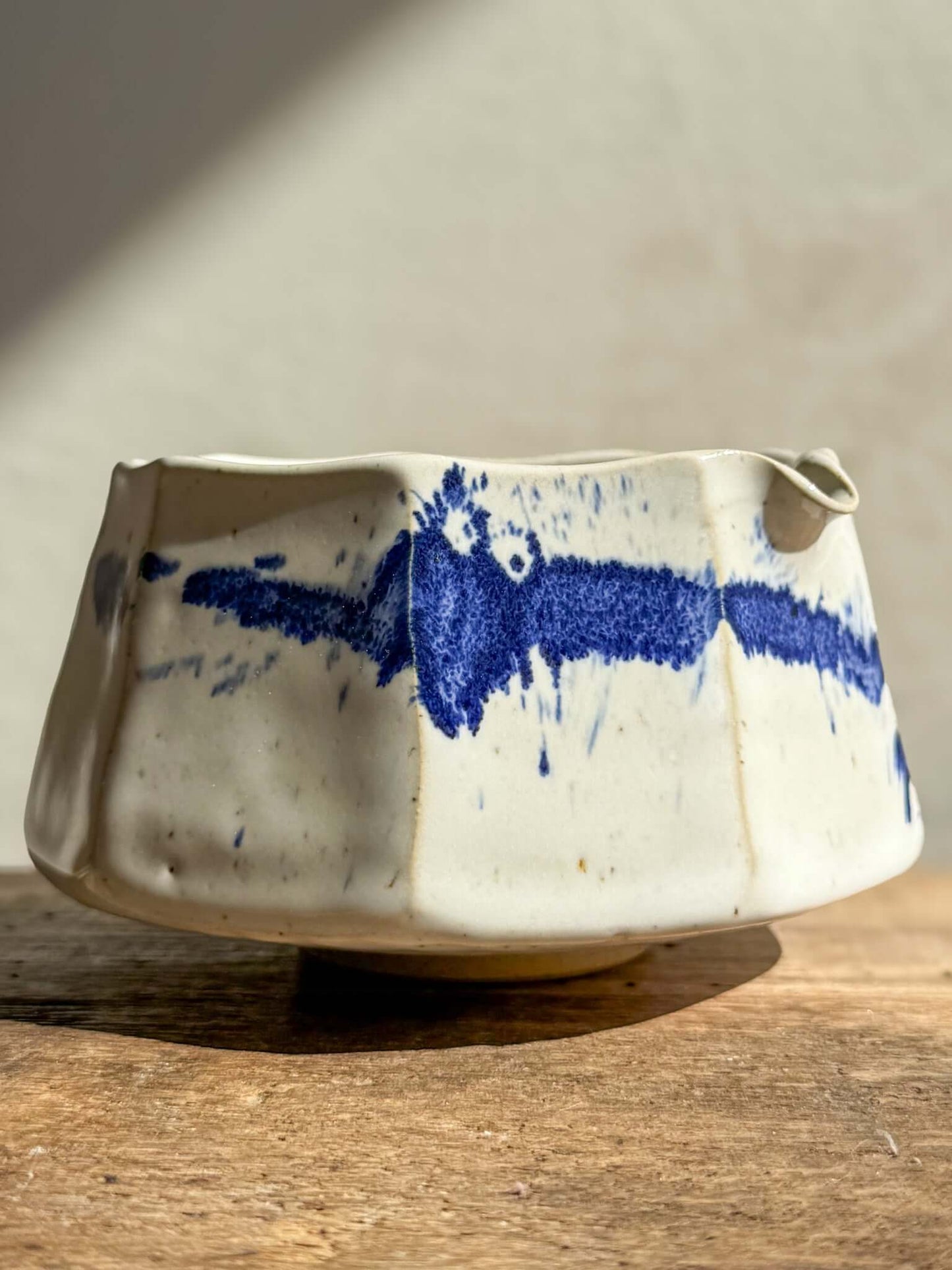 Faceted Matcha Bowl with Spout in Cobalt Blue and Glossy White Glaze, showing hand-splashed blue accents and textured design.