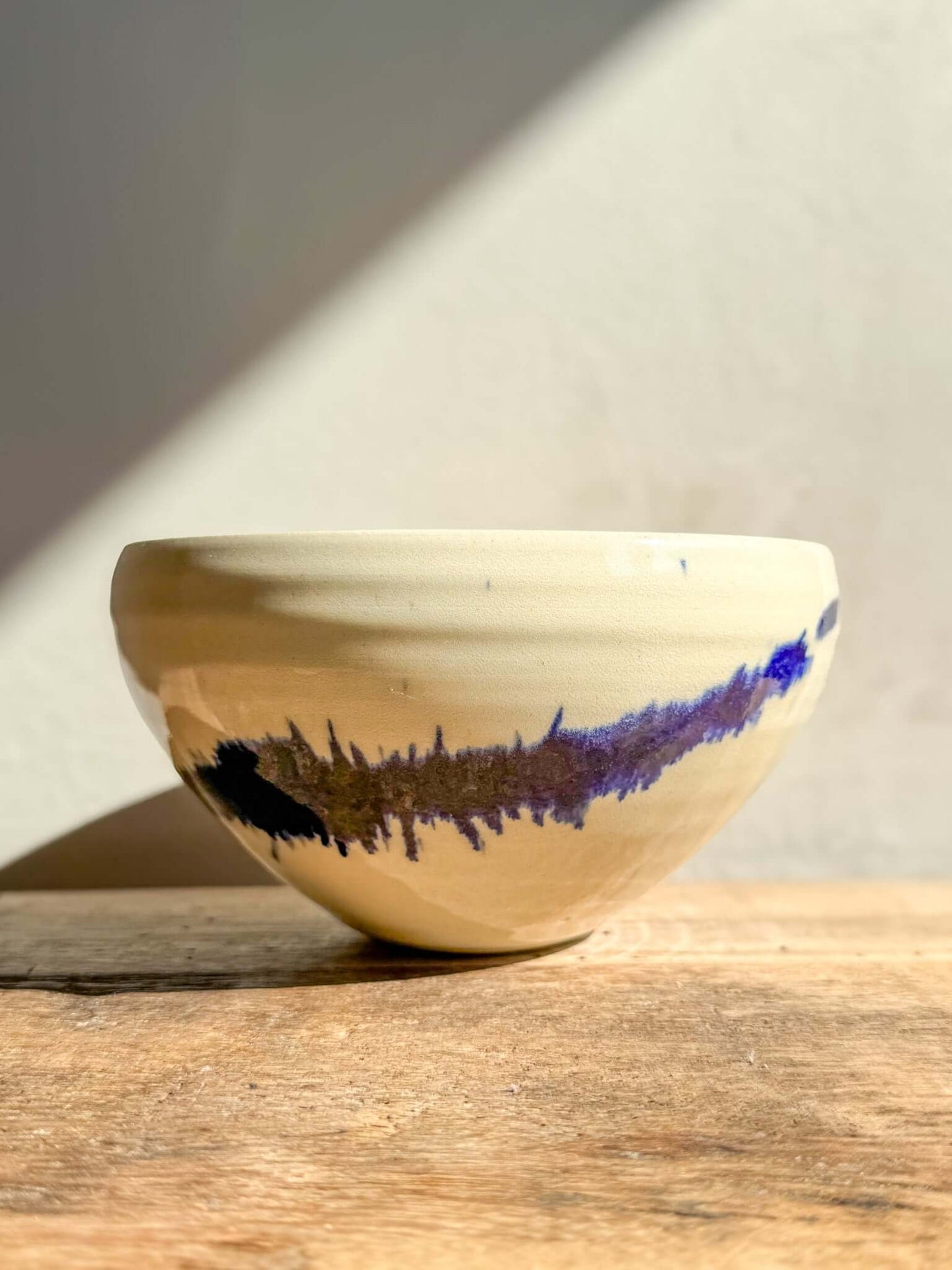 Rounded medium Gosu Series bowl with bold cobalt blue splashes on soft glaze, ideal for breakfast or small meals, unique design.