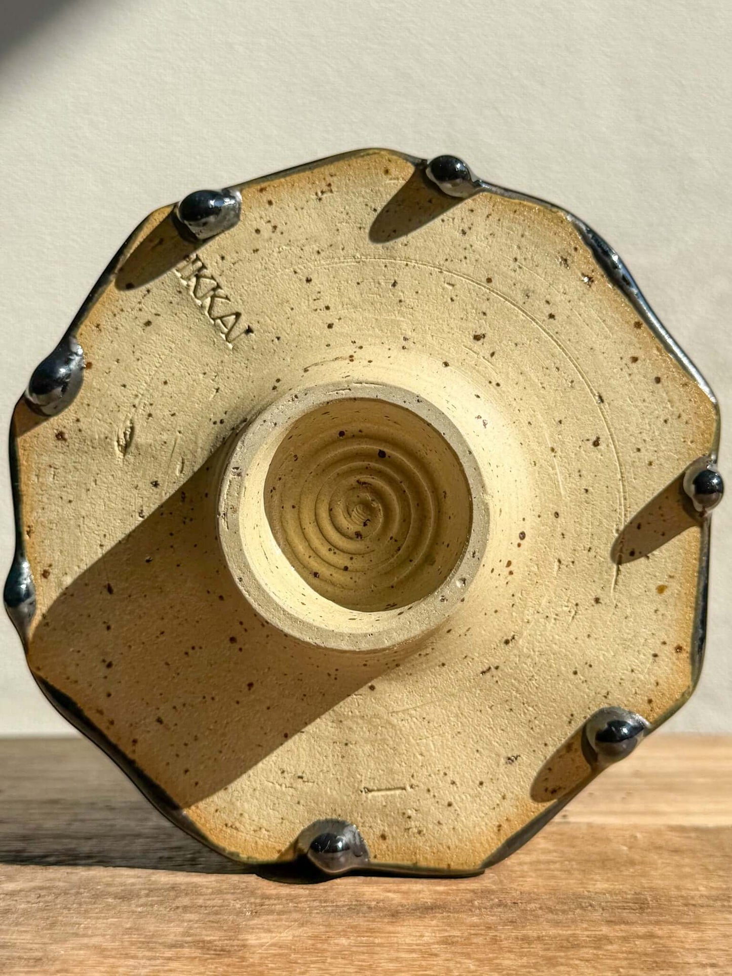 Underside view of faceted matcha bowl from Hinoki Series #03, showcasing unique glaze drips and hand-carved facets.