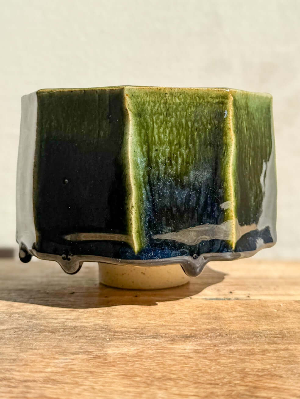 Faceted matcha bowl with deep green glaze from Hinoki Series, displaying carved lines and rich glaze pools, handcrafted and unique.