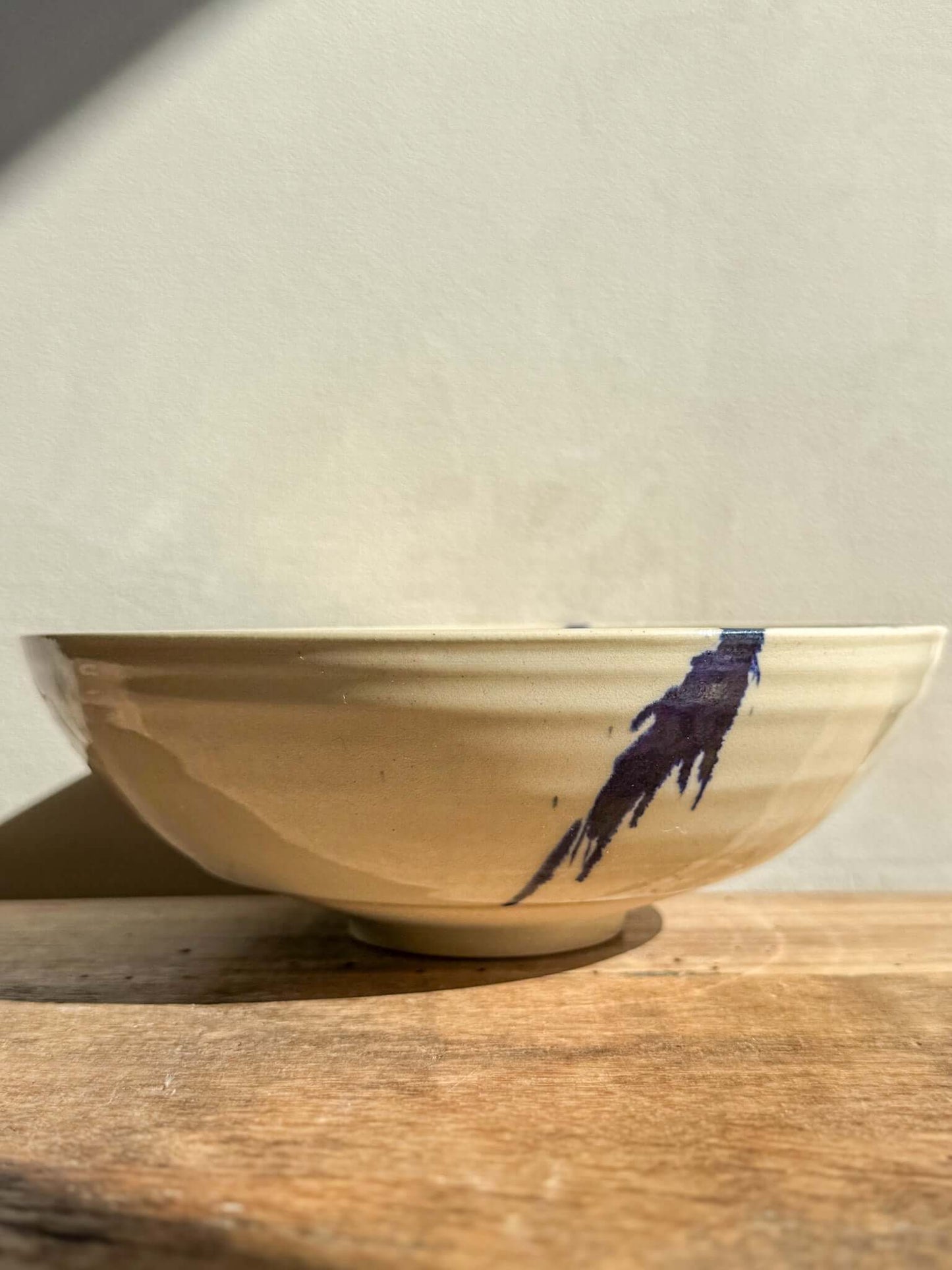 Side view of a Lidded Serving Bowl from the Gosu Series with cobalt splashes, showing the elegant design and handcrafted texture.