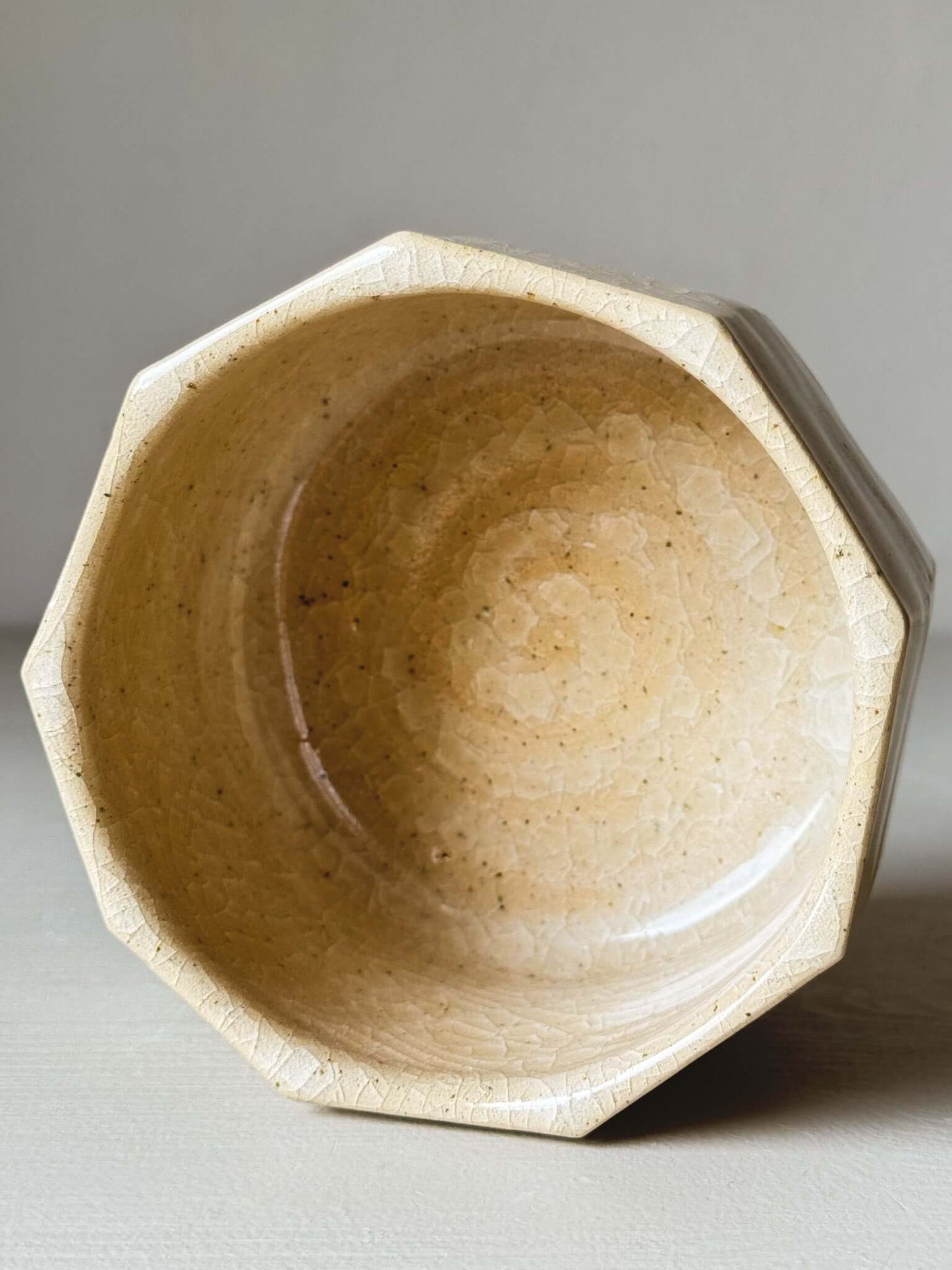 Faceted matcha bowl with honey-toned crackle glaze, featuring geometric design and wabi-sabi aesthetics for slow mornings.
