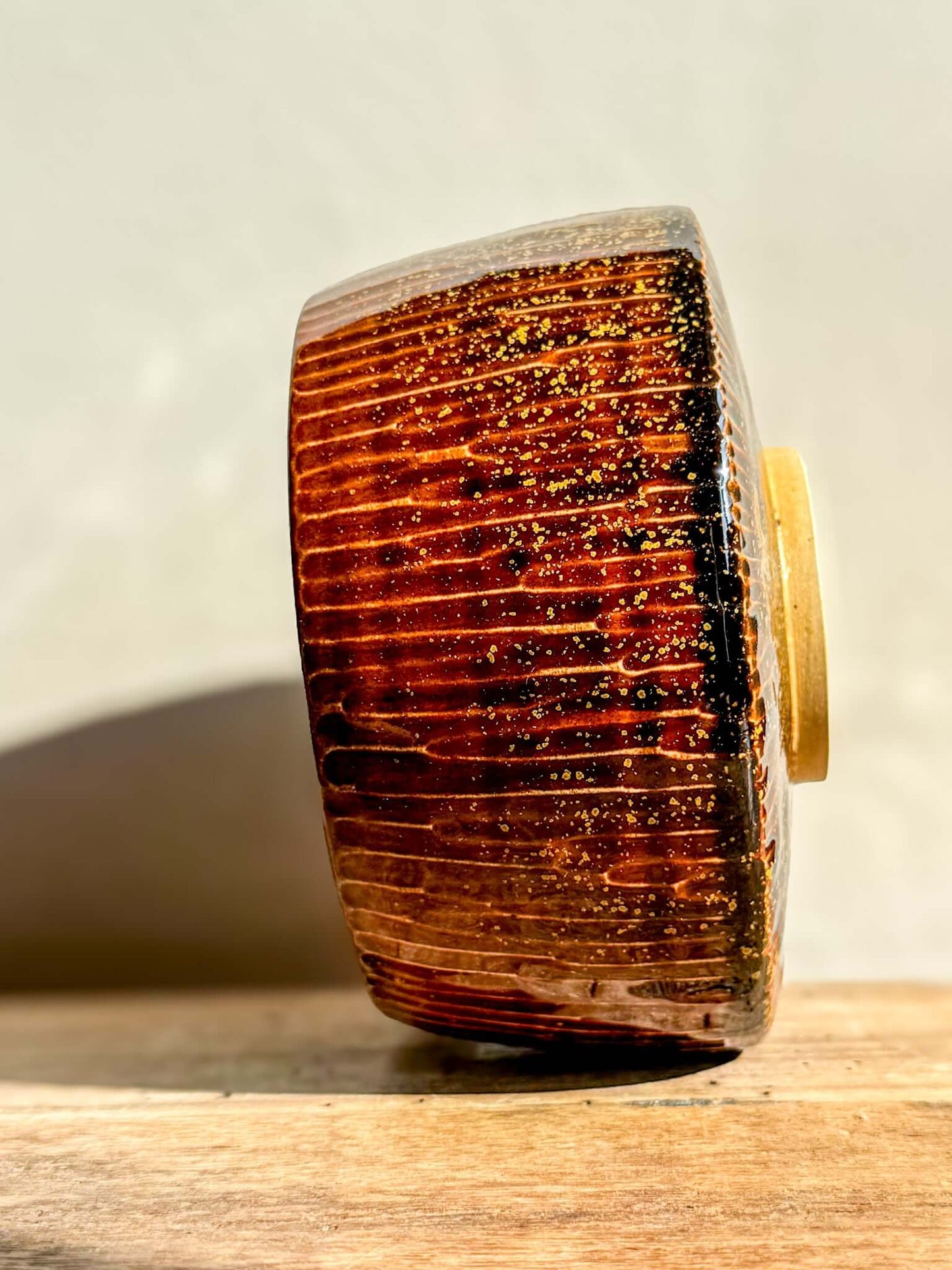Kinsei Matcha Bowl #03 featuring glossy brown glaze with gold speckles, resembling a galaxy in rich, earthy tones.
