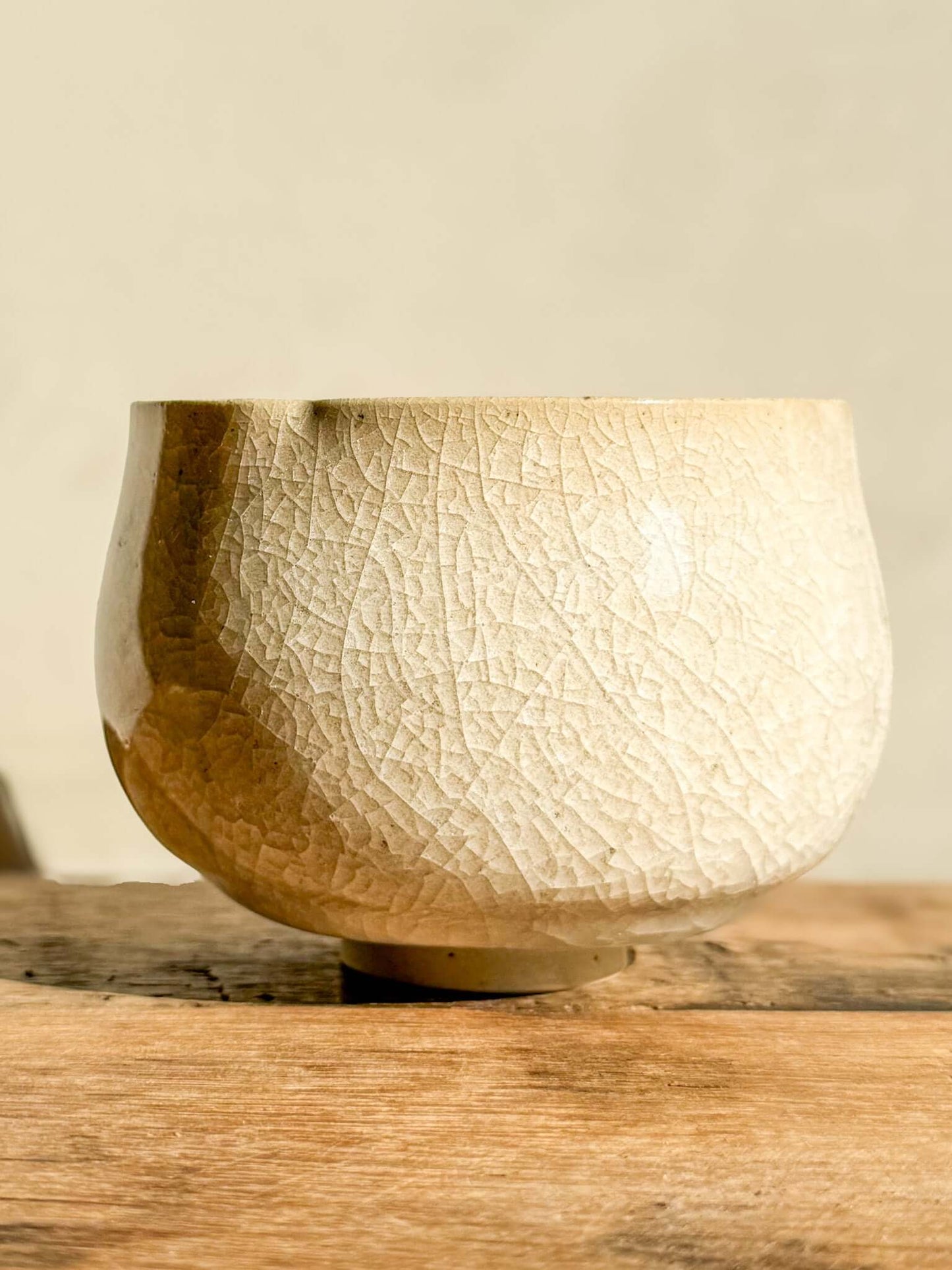Yunomi Cup Kannyū Series #01 with crackle glaze pattern, showcasing elegant lines and soft flowing rim, on a wooden surface.